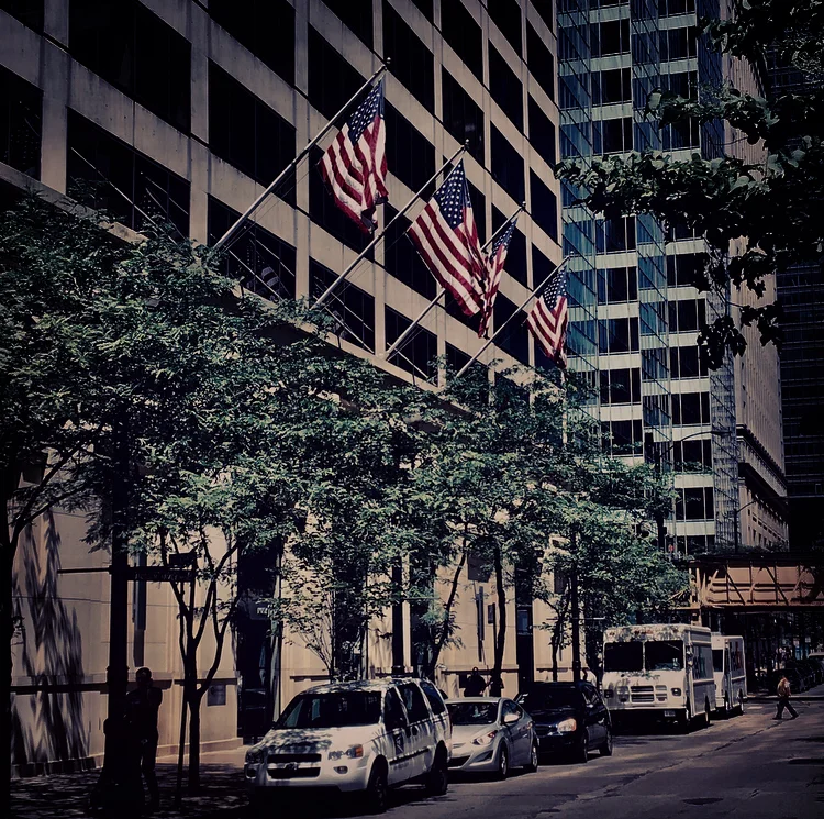 “A figure emerges, heading down the city sidewalk past a stone office building. Four American flags jut from its ledge over a row of giant revolving doors. My stomach makes a slow roll. I recognize him by the way he walks—it’s my dad.”