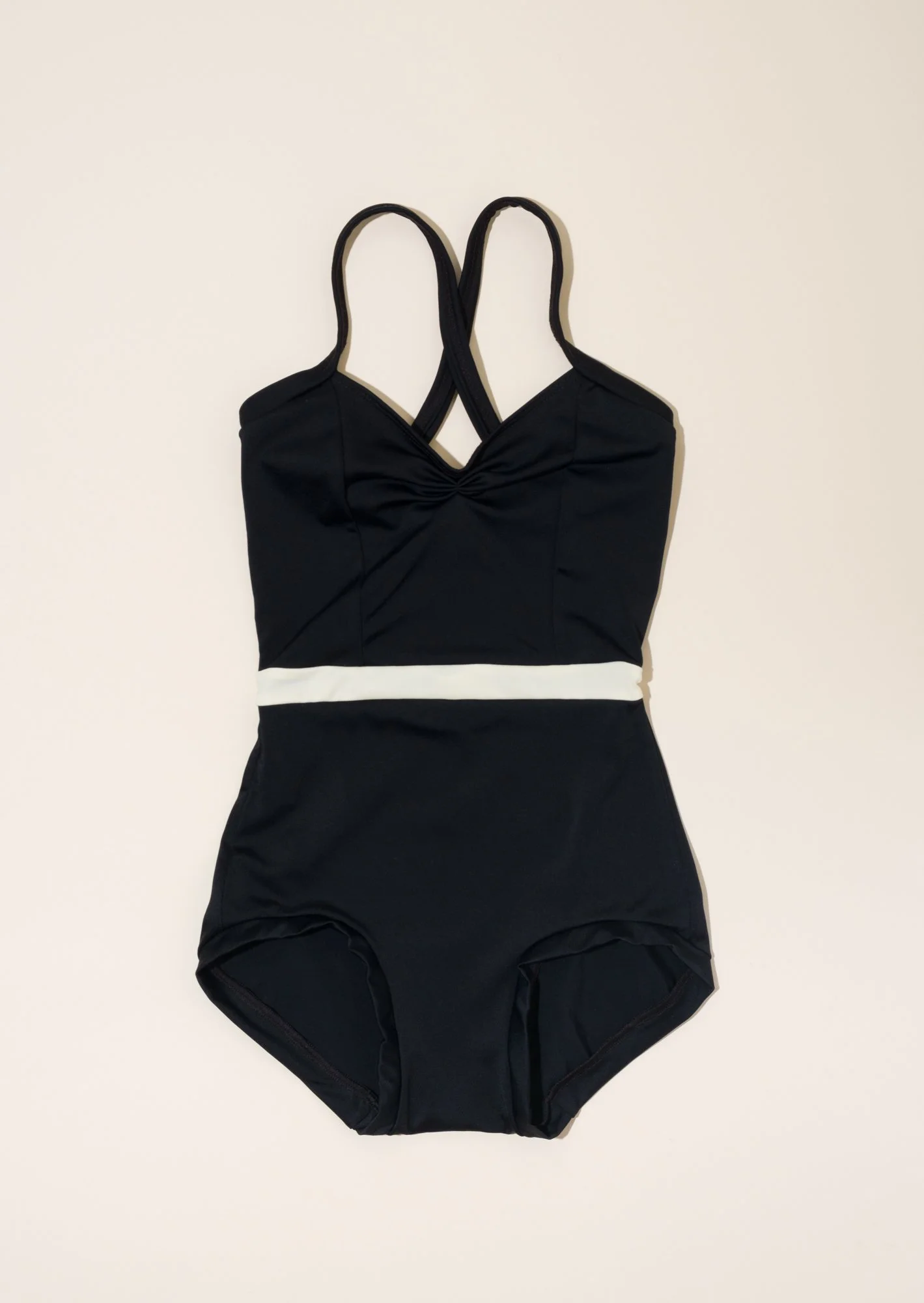 The bettie leotard in black with an antique white waist