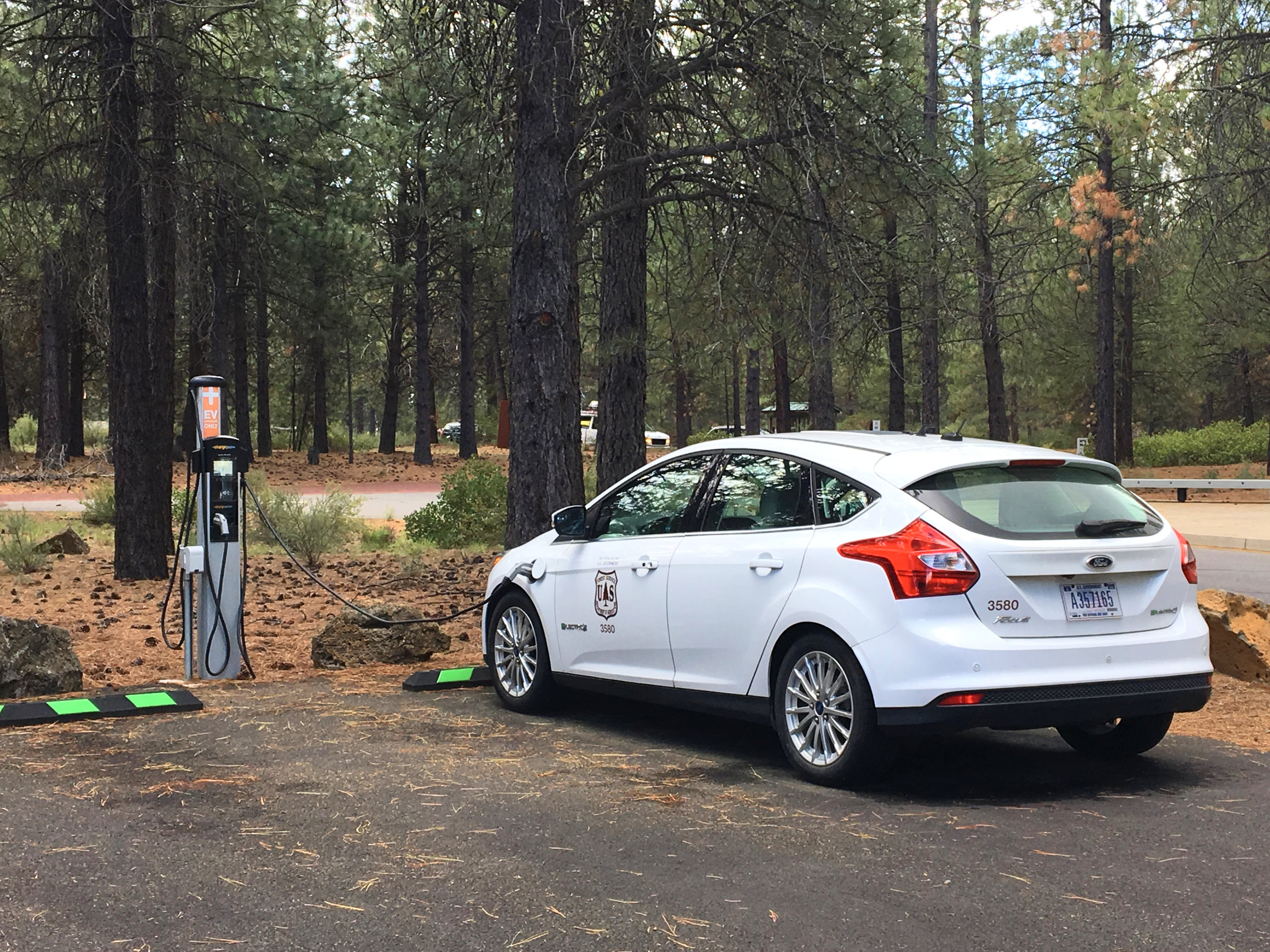  The U.S. Forest Service charges up their electric vehicle at Lava Lands Visitor Center, part of the  Newberry National Volcanic Monument .  