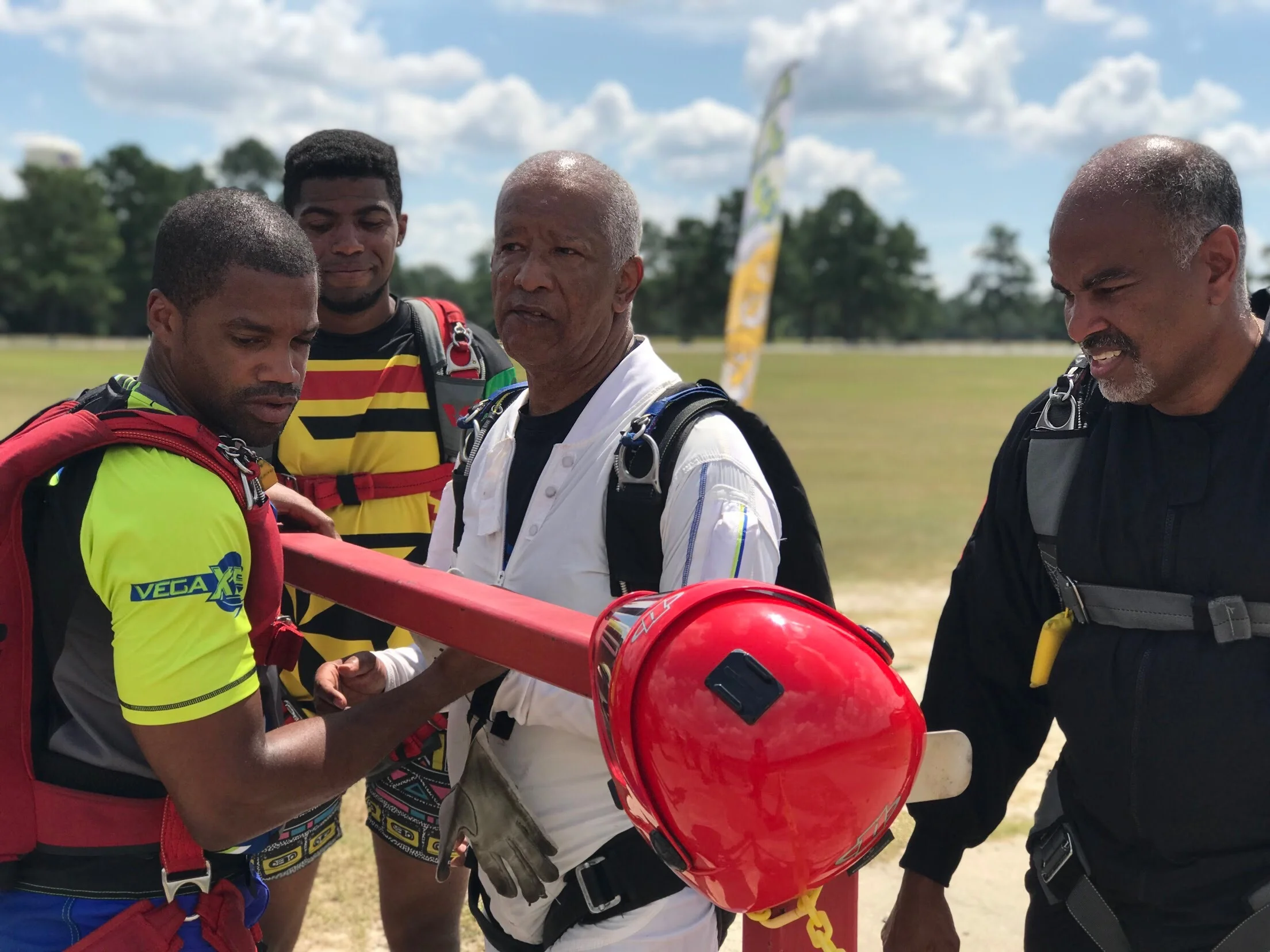 Nick (far left) coaches Team Blackstar skydivers on how to properly conduct a linked exit. Harrison Wallace (second from right) started skydiving in 1972. Dónte Caul (2nd from left) began skydiving in 2018.