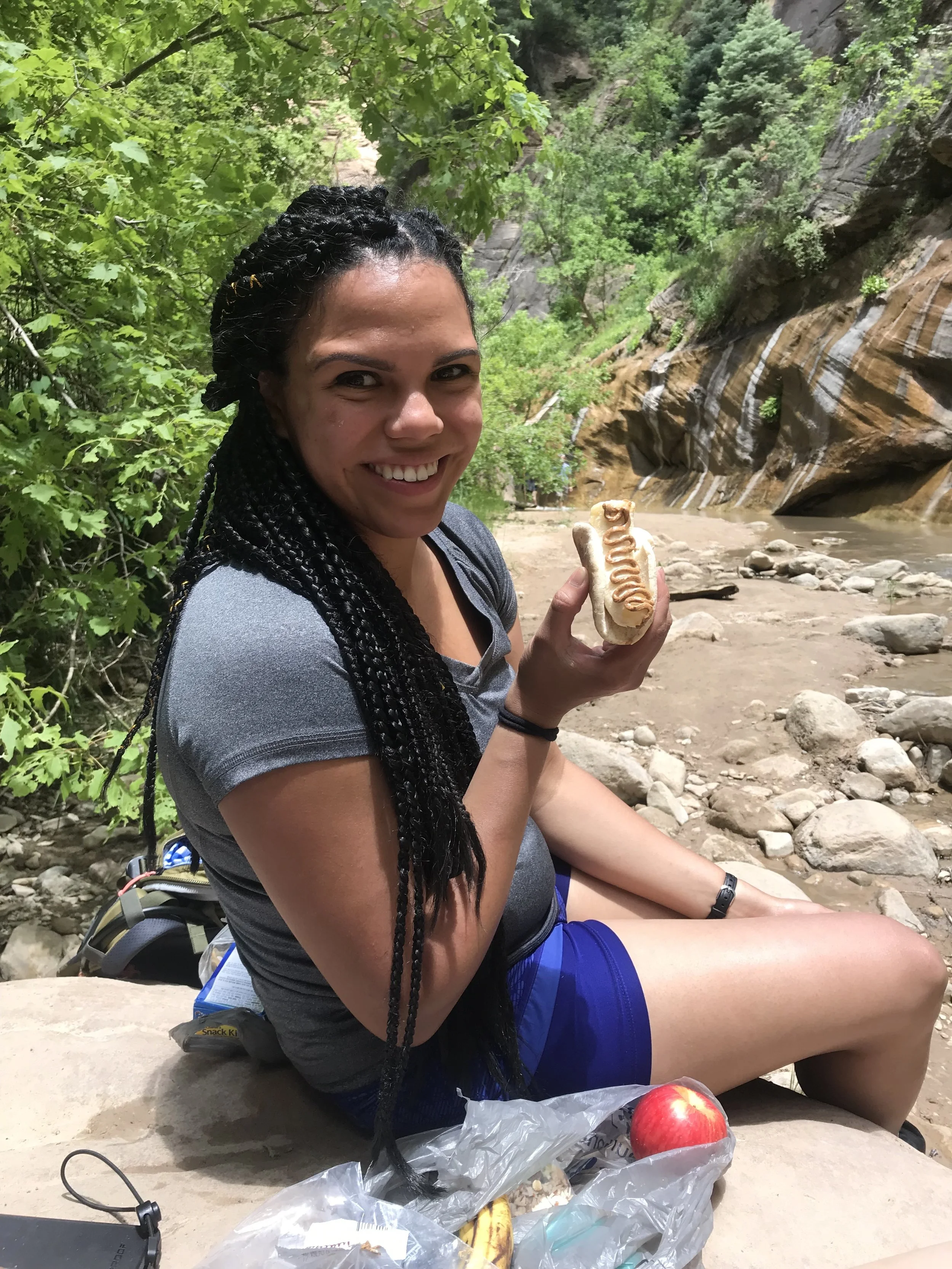 Nadia eating a banana on a bagel thin with an almond butter topping. Photo taken by Amber Saterlee