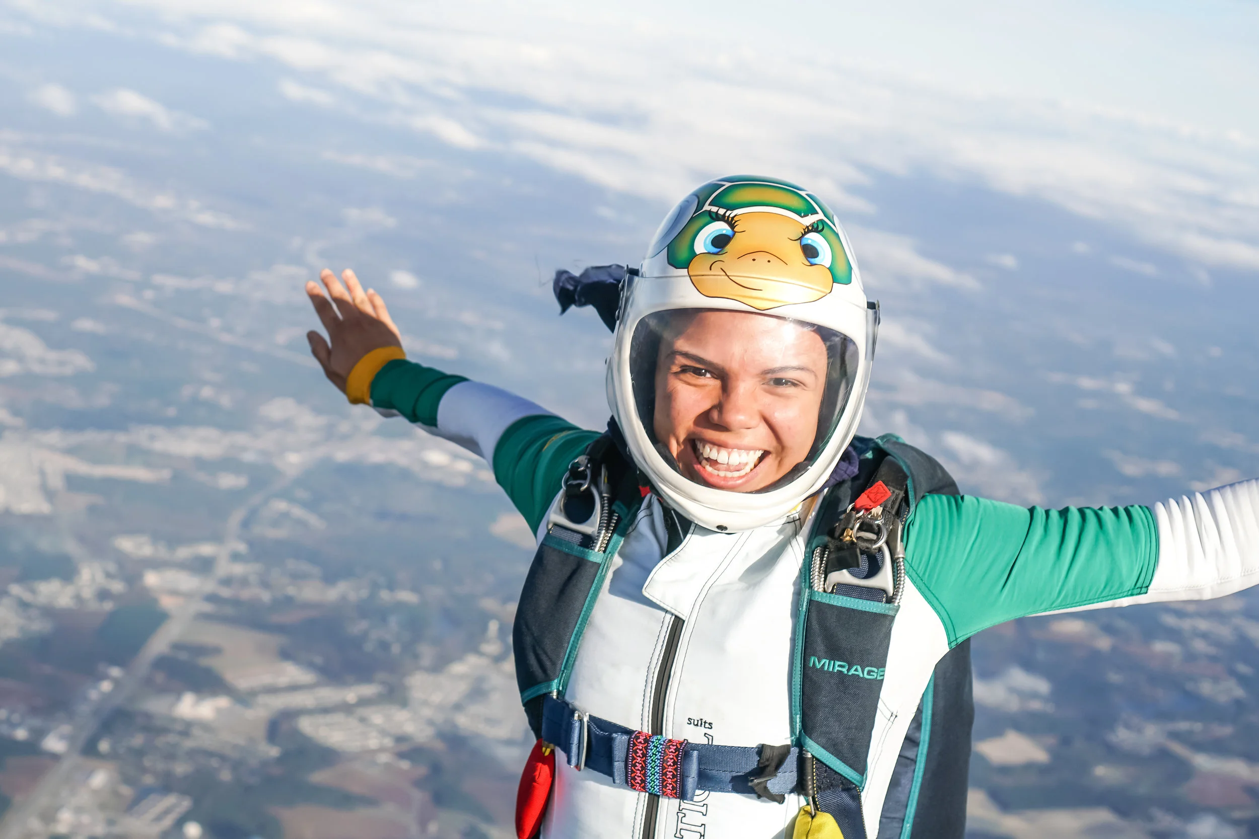 Covering her hair with a buff underneath her skydiving helmet helps protect her curls from 120mph winds. Photo courtesy of Elliot Byrd