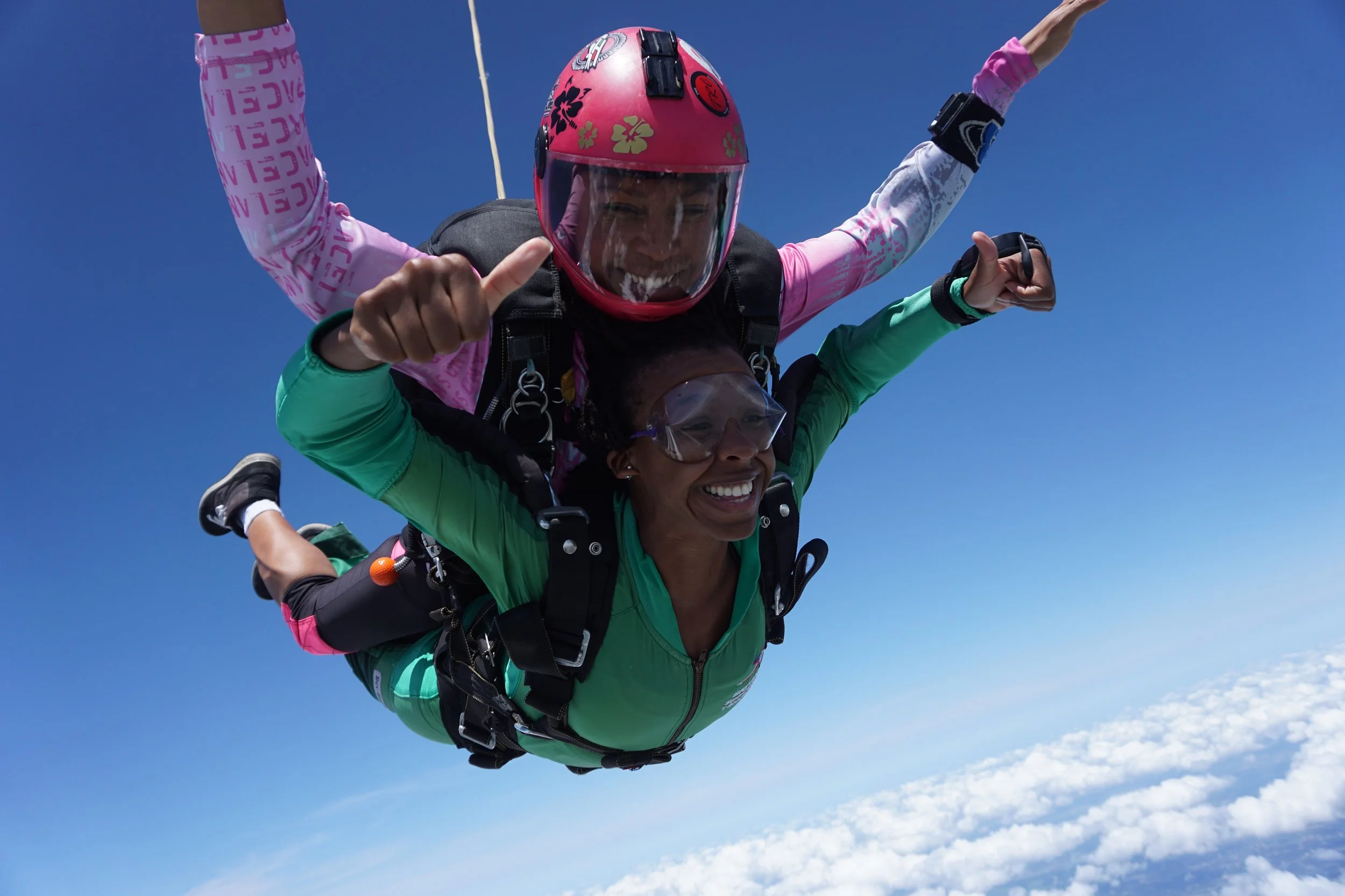 Afro-Mexican tandem instructor Erendira Sanchez González (pink helmet) started skydiving when she was 15-years-old. She comes from a family of skydivers—her father has over 22,000 jumps. Photo courtesy of Woodbury Roland