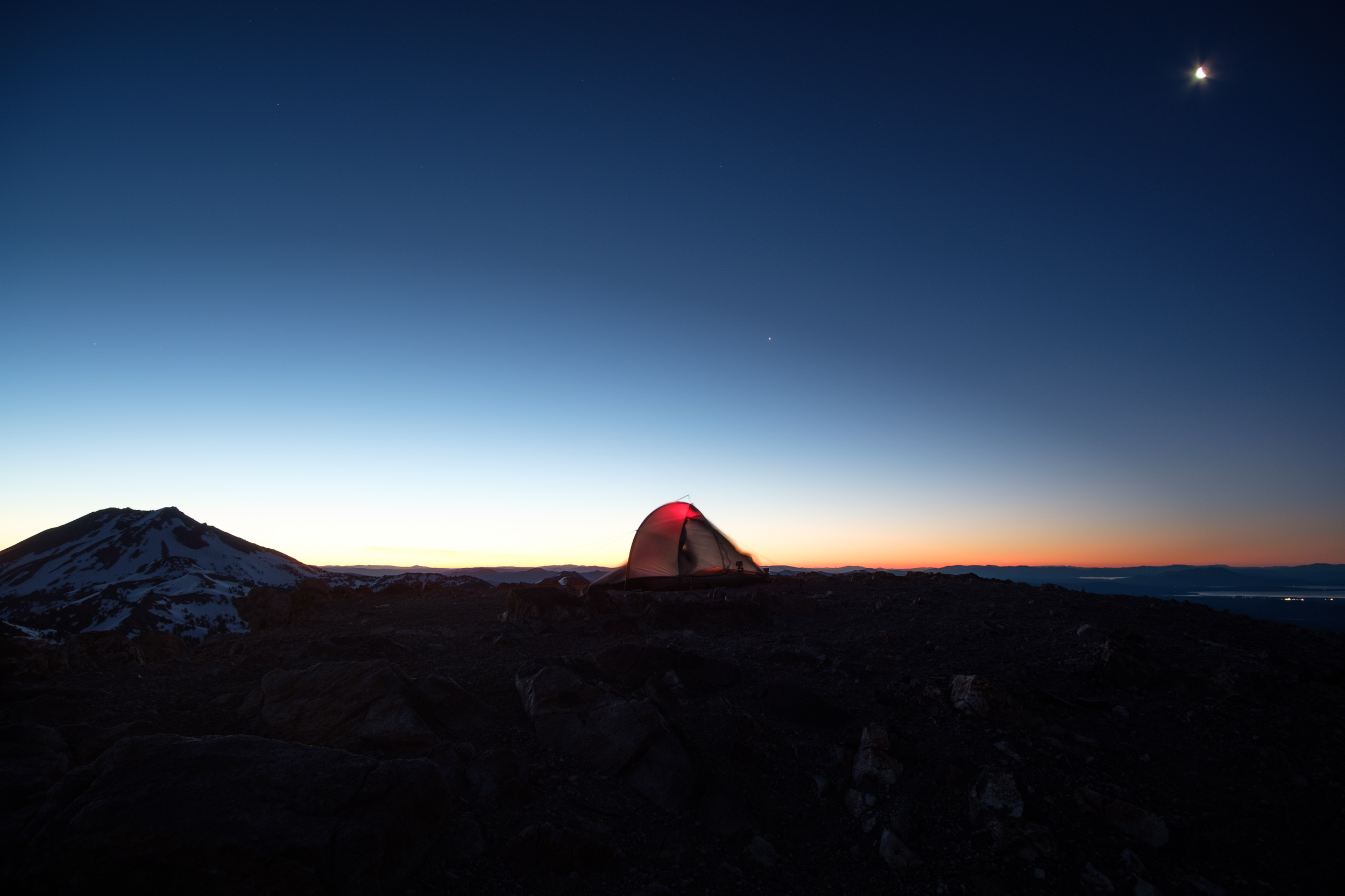 My tent leaning from high winds on the summit of Brokeoff Mountain (9,236'). Lassen Peak and the moon in the background. Lassen Volcanic National Park, California. 