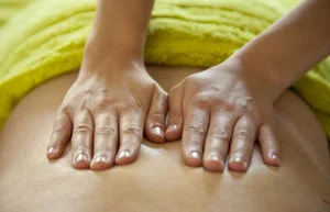 Hands giving a relaxing back massage