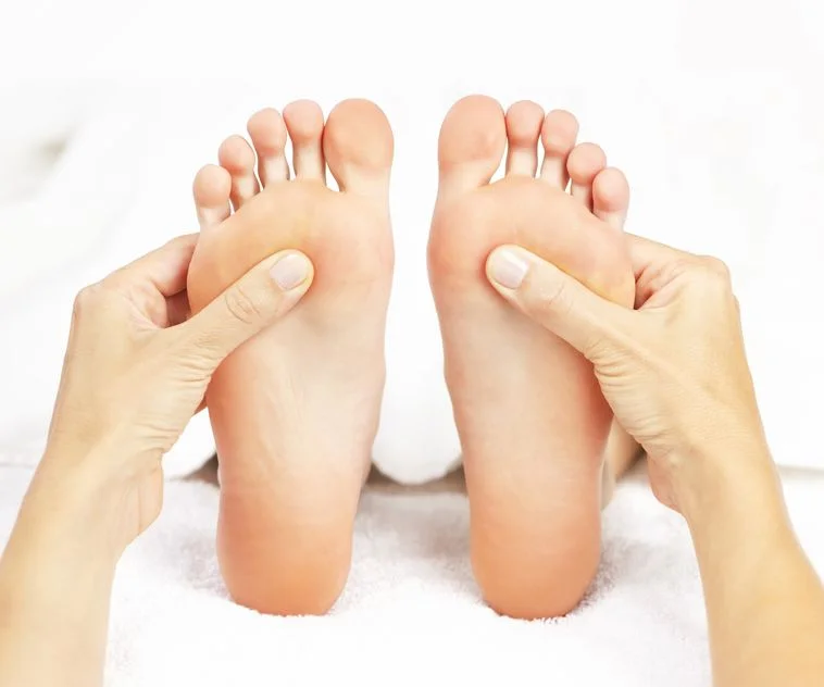 Reflexology treatment focusing on the feet as part of a chakra balancing experience