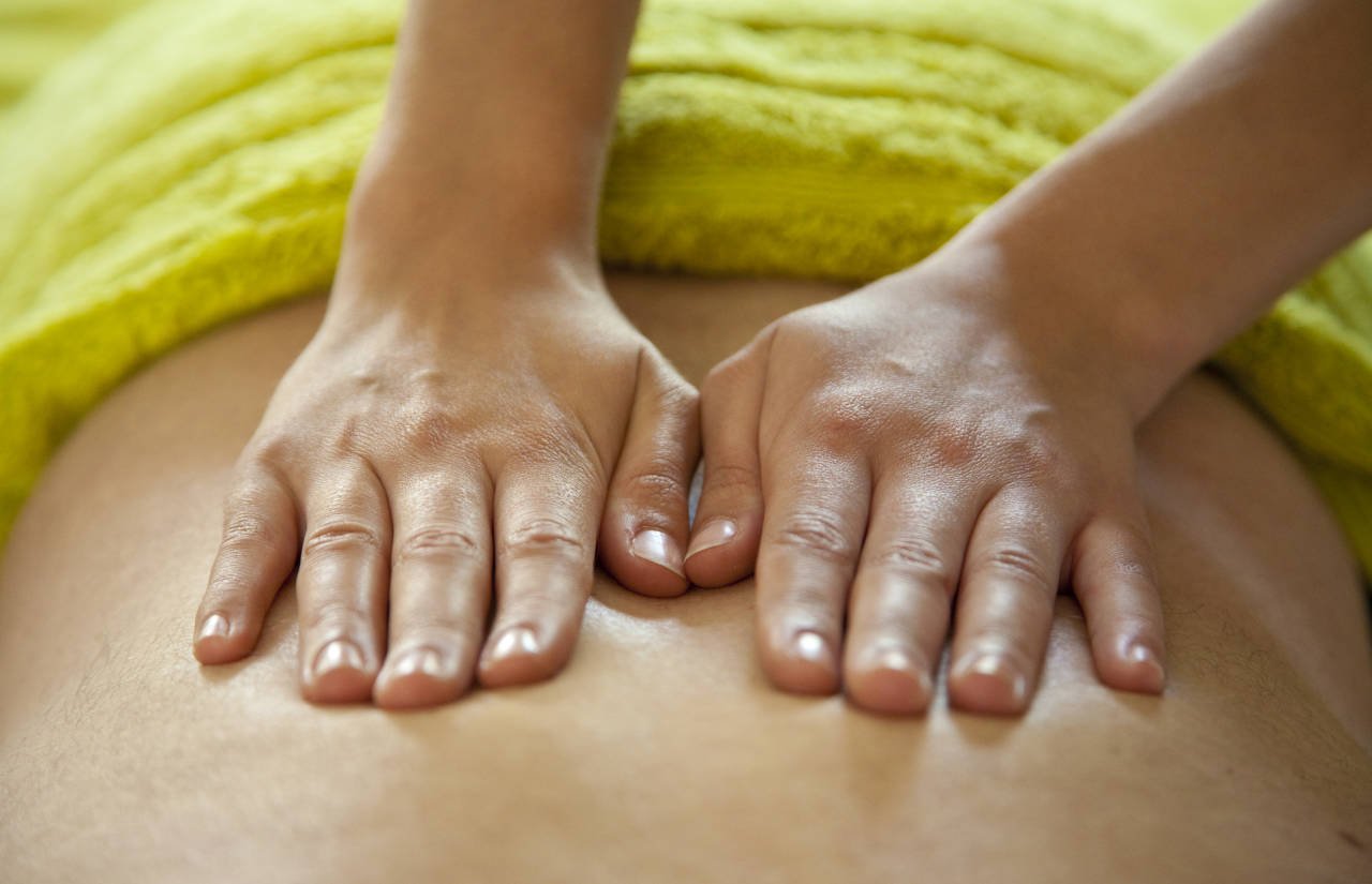 Hands giving a relaxing back massage