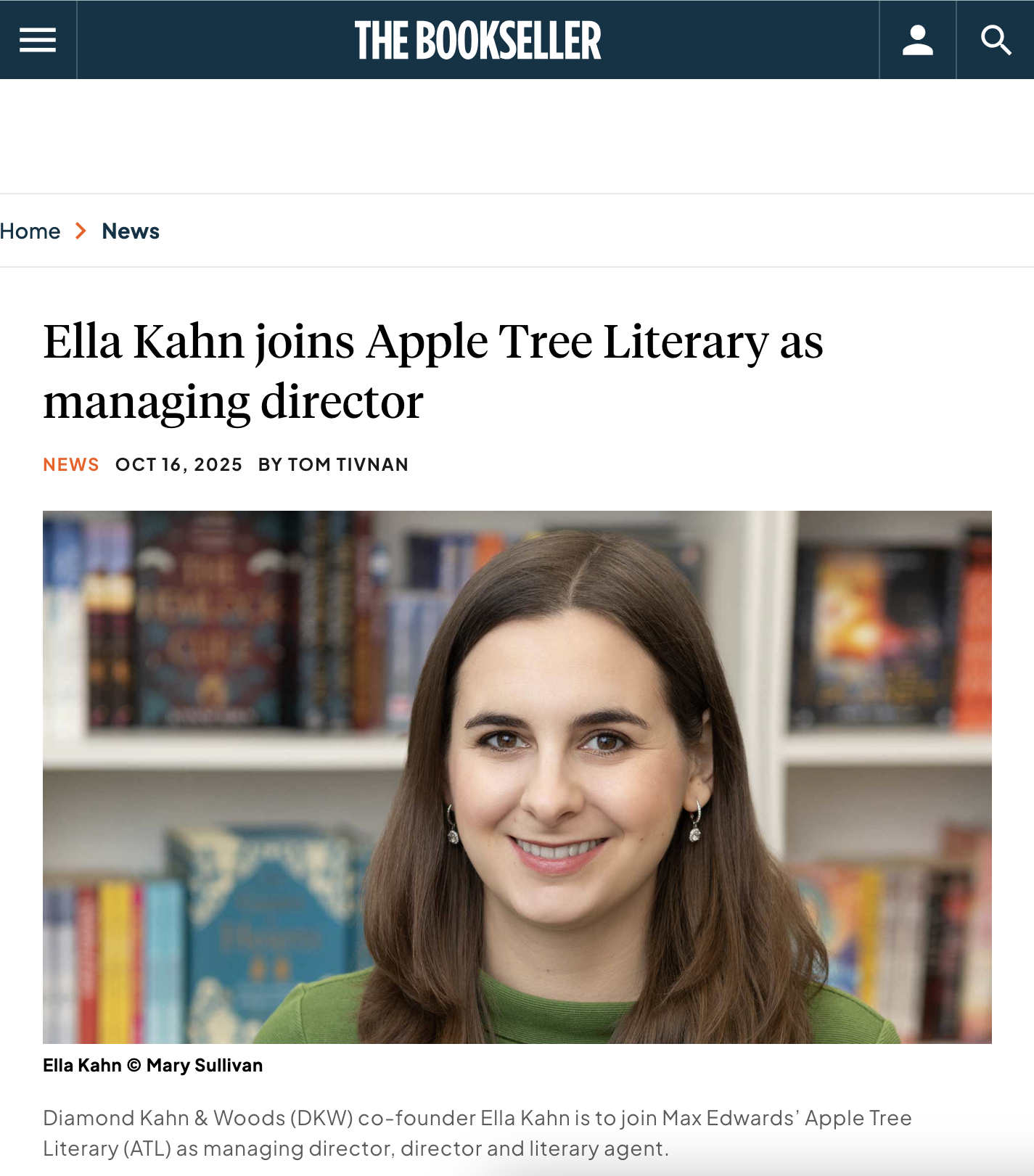 Headshot of Ella Kahn, a young woman with long brown hair, smiling, in front of bookshelves filled with colorful books. Featured on Bookseller website. 