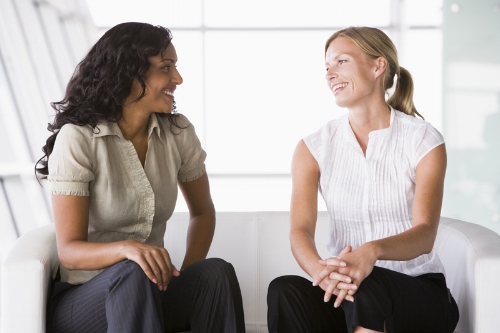 2-women-sat-talking-on-a-couch.jpg