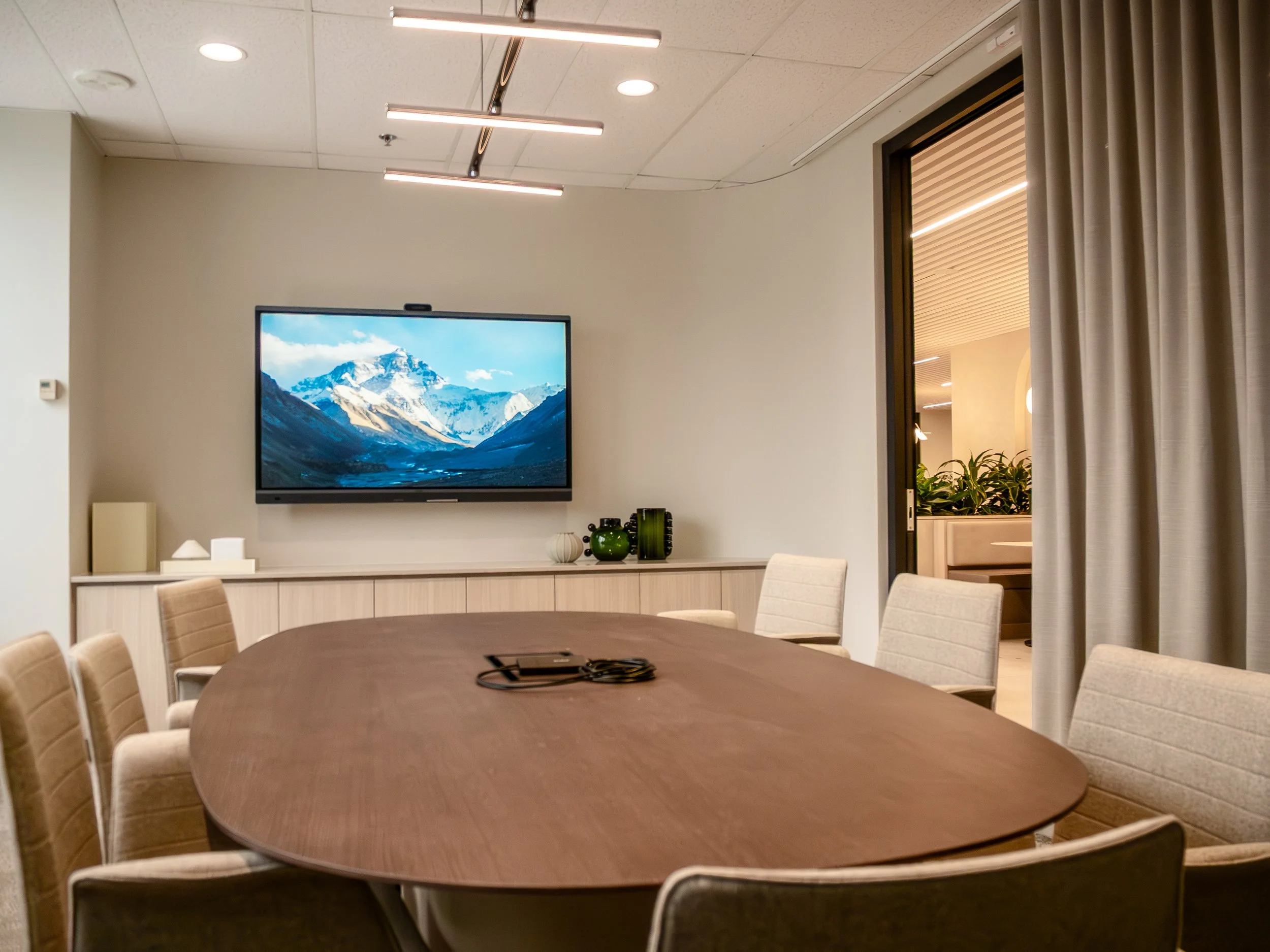 Modern boardroom with an active sound masking system and interactive display
