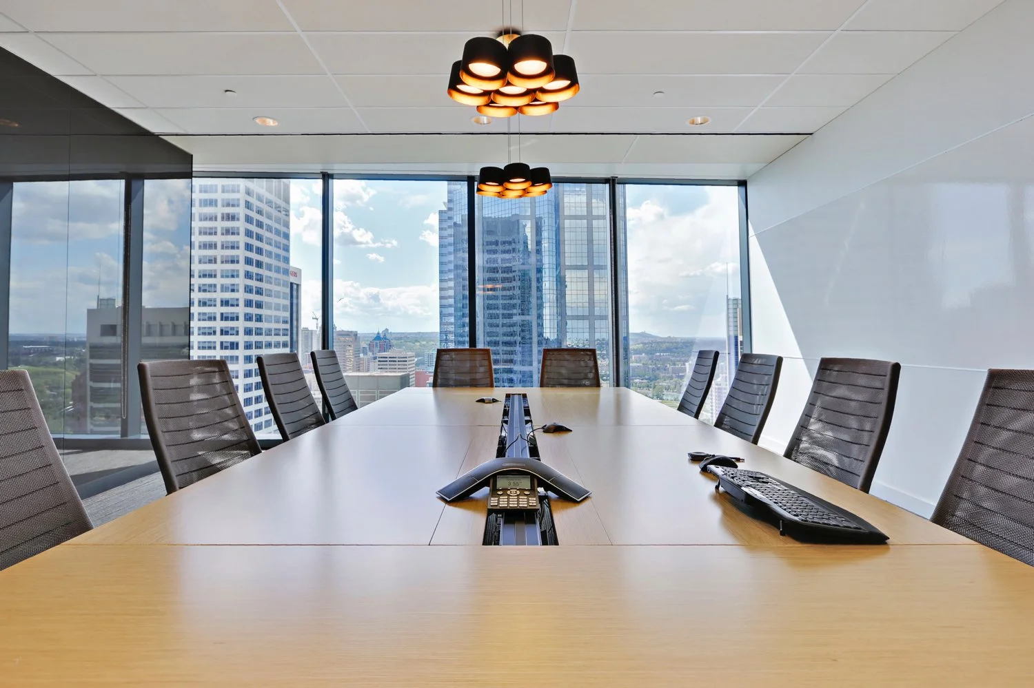 Conference table in a Canadian high rise boardroom with AV meeting technology
