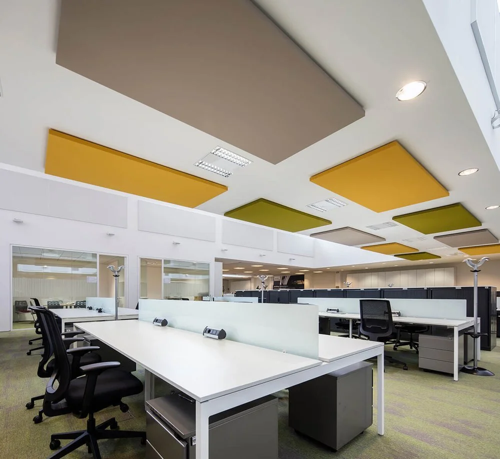 Brown, yellow, and green Acoustic Panels in an open-plan office space designed to reduce echoes and sound reverberation
