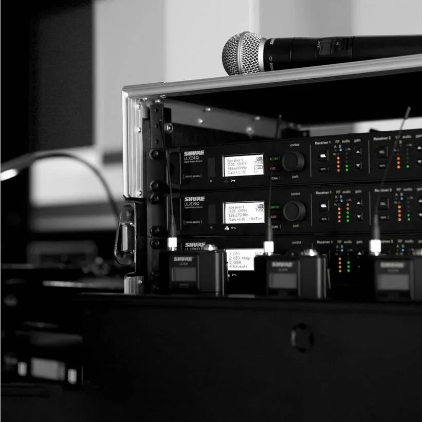 Rack-mounted ULX-D Quad Receivers and rechargeable wireless microphone transmitters