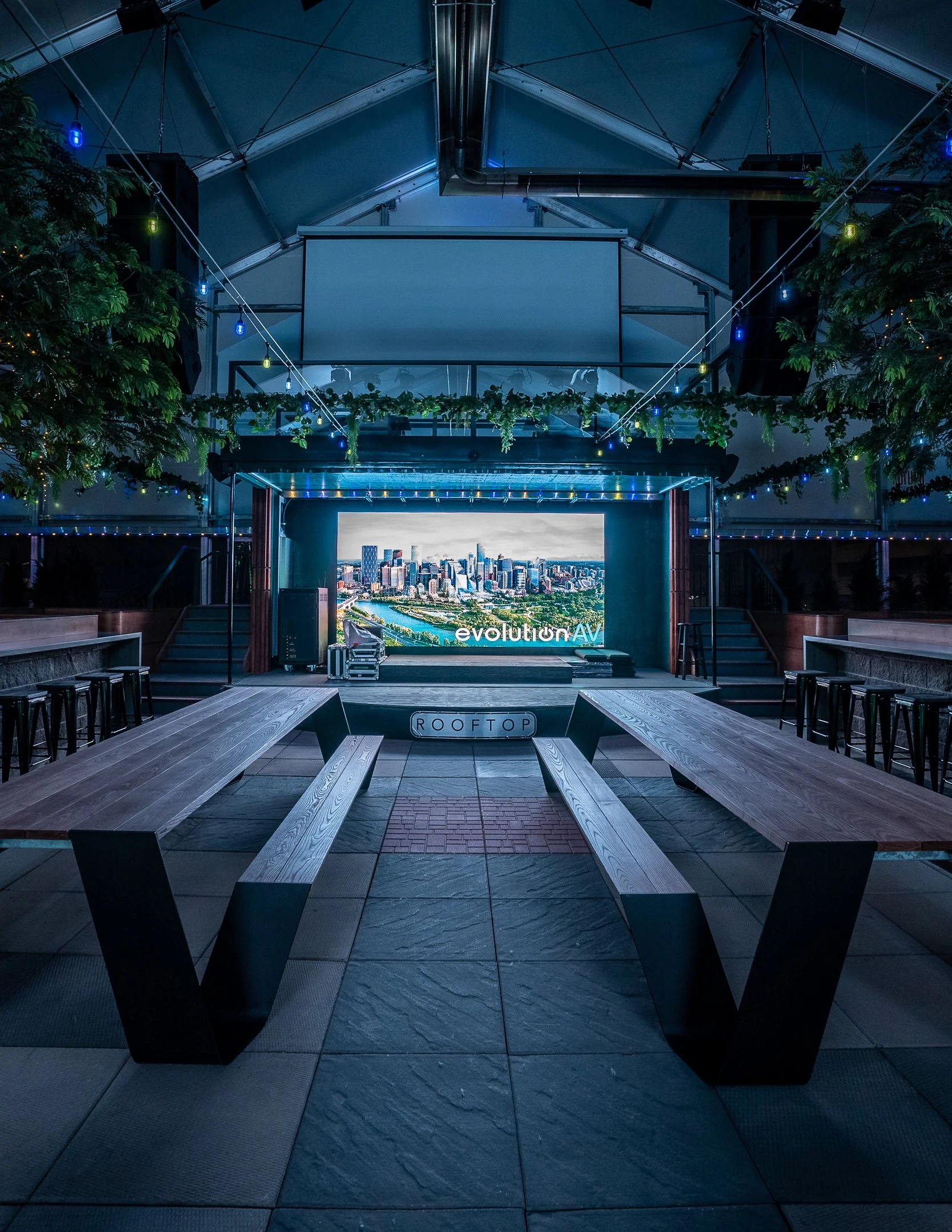 LED wall in the Rooftop bar in Calgary with a projector and  colourful lighting