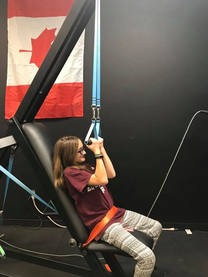 Girl pulling down on innovative health and performance outstrip exercise bands