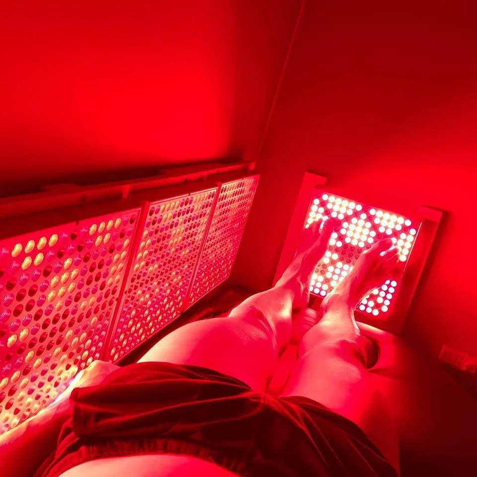 Person’s view of feet inside Innovative Health and Performance REDjuvenator red light therapy chamber