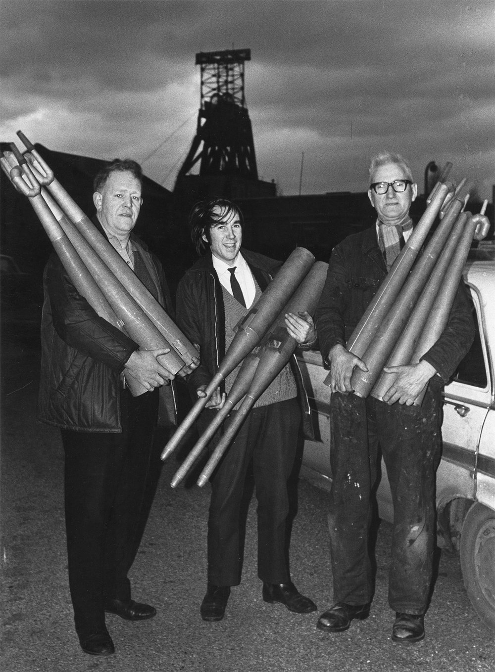 Founding members of the Harworth Christie Organ Enthusiasts carrying organ pipes in the colliery yard, Harworth Colliery, Nottinghamshire.