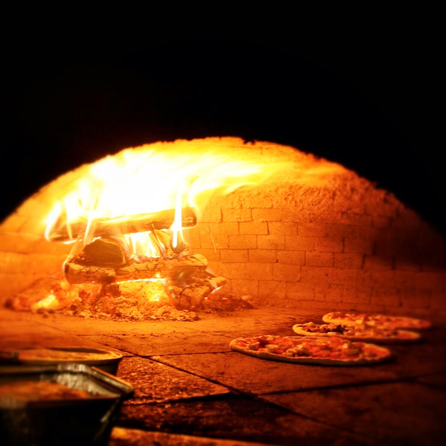 Wood Burning Oven with Pizza Cooking on the Hearth