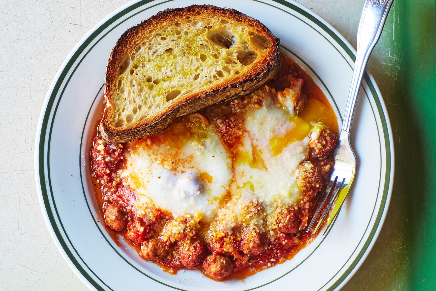 Baked Eggs in Our Baby Meatball Ragu