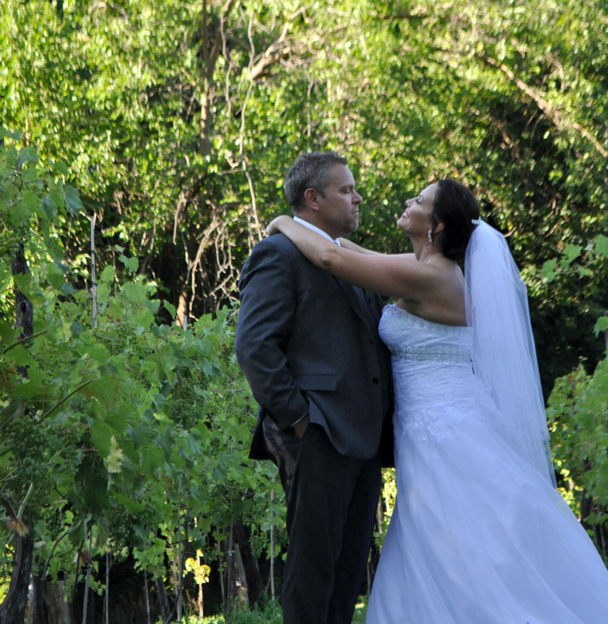 bride and groom at mallinson vineyard and hall at sugar creek mo.jpg