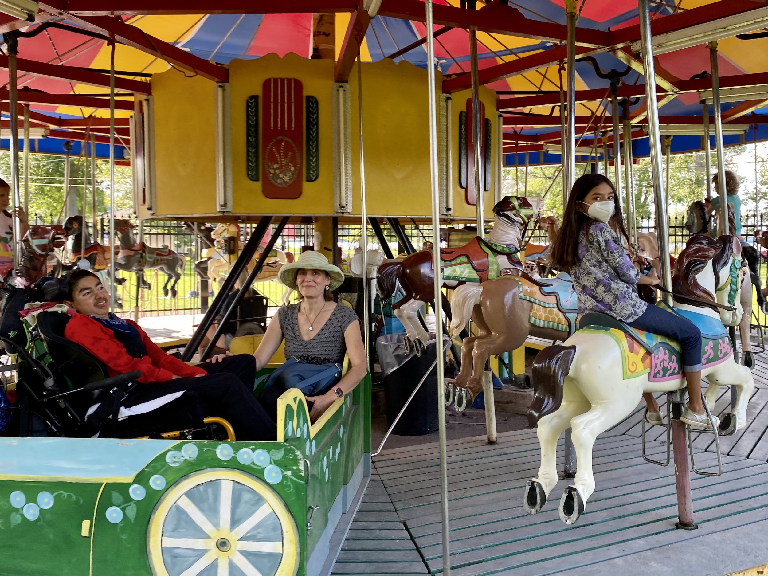 Oli and family accessible carousel.jpg