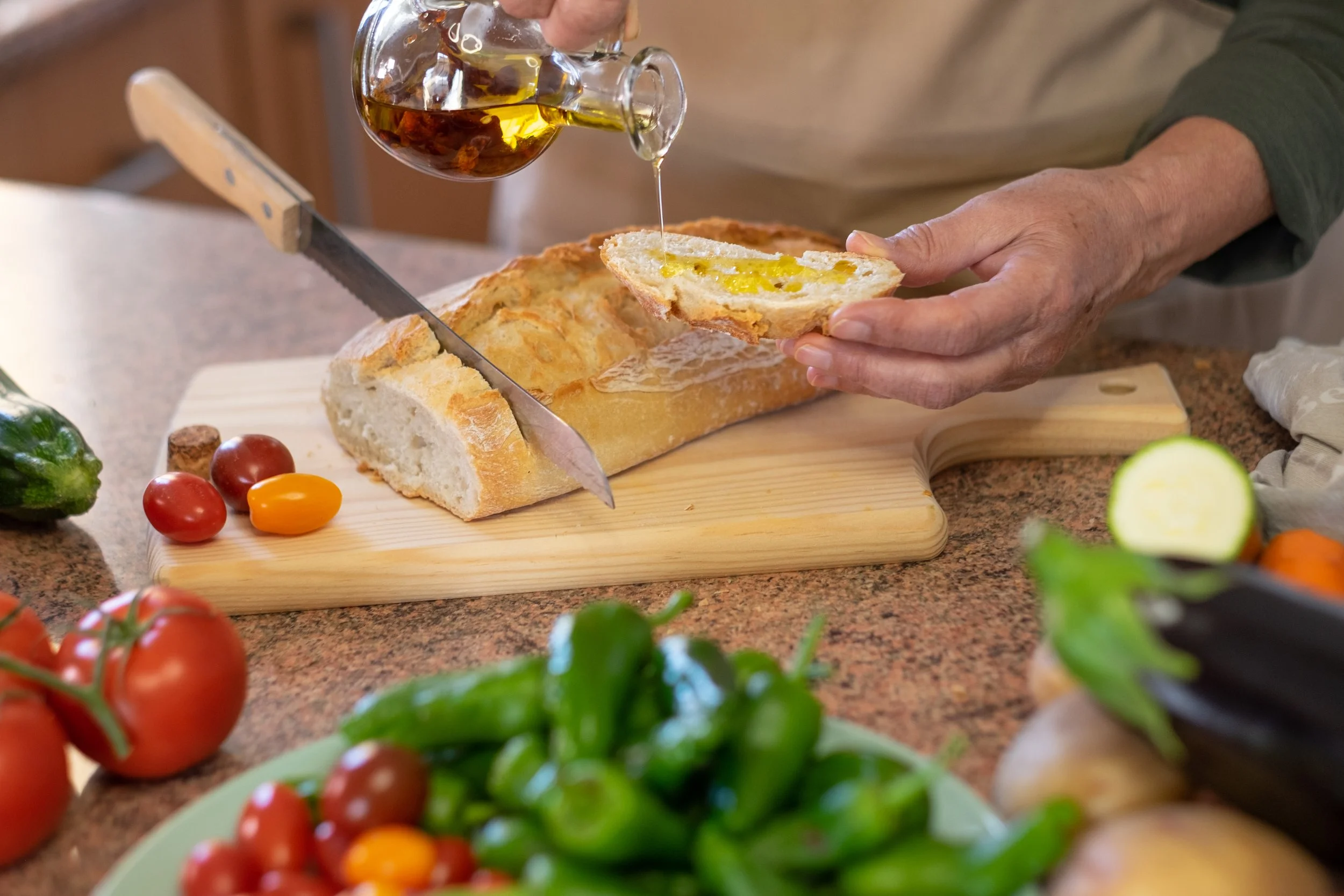 slices-rustic-bread-wooden-cutting-board-two-woman-s-hands-preparing-snack-with-tomato-bruschetta-spicy-oil-assortment-fresh-vegetables-table.jpg