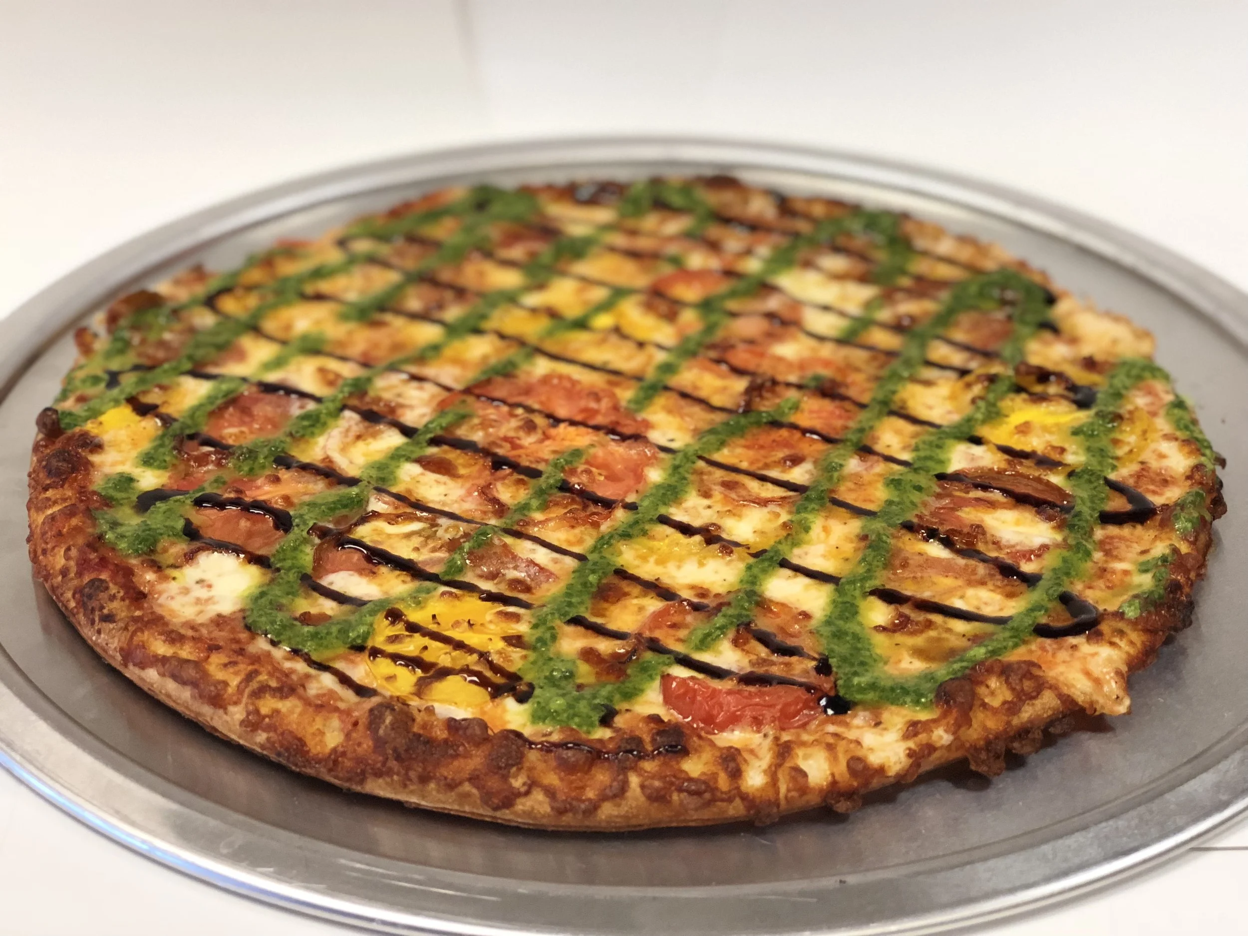 Piper’s Margherita Pizza! This tasty Thin Crust pizza starts with our house-made marinara sauce, garlic, and mozzarella cheese. Then it’s topped with fresh sliced heirloom tomatoes and a drizzle of balsamic glaze and basil pesto. Small Medium Large X-Large $15.99 $19.46 $22.69 $25.25