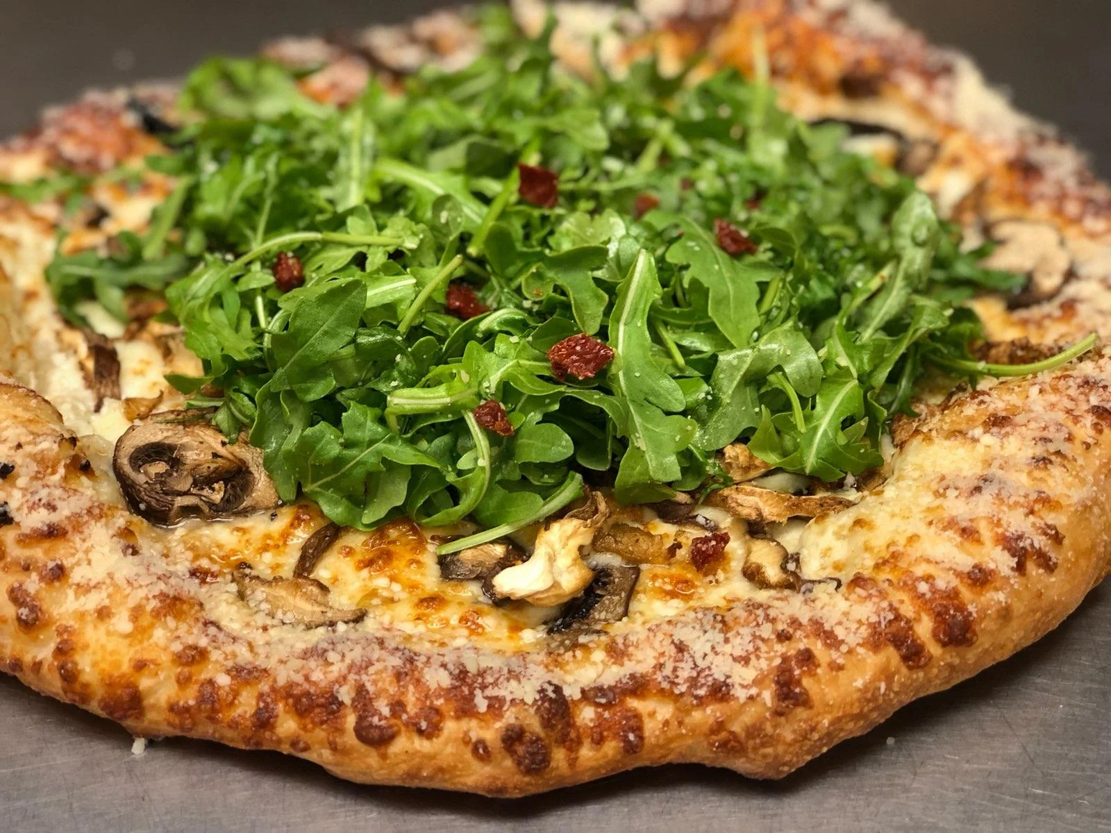 Double-A Wild Mushroom Pizza This delicious pizza starts with Alfredo sauce, and gets loaded with our wild mushroom blend and mozzarella cheese. Then baked and topped with baby arugula tossed in olive oil, Parmesan, a pinch of salt, sun-dried tomatoes, and an olive oil-Parmesan crust. Small Medium Large X-Large $17.68 $20.68 $23.38 $25.44 Our wild mushroom mix contains Portabella, Shitake, Cremini, and Oyster mushrooms.
