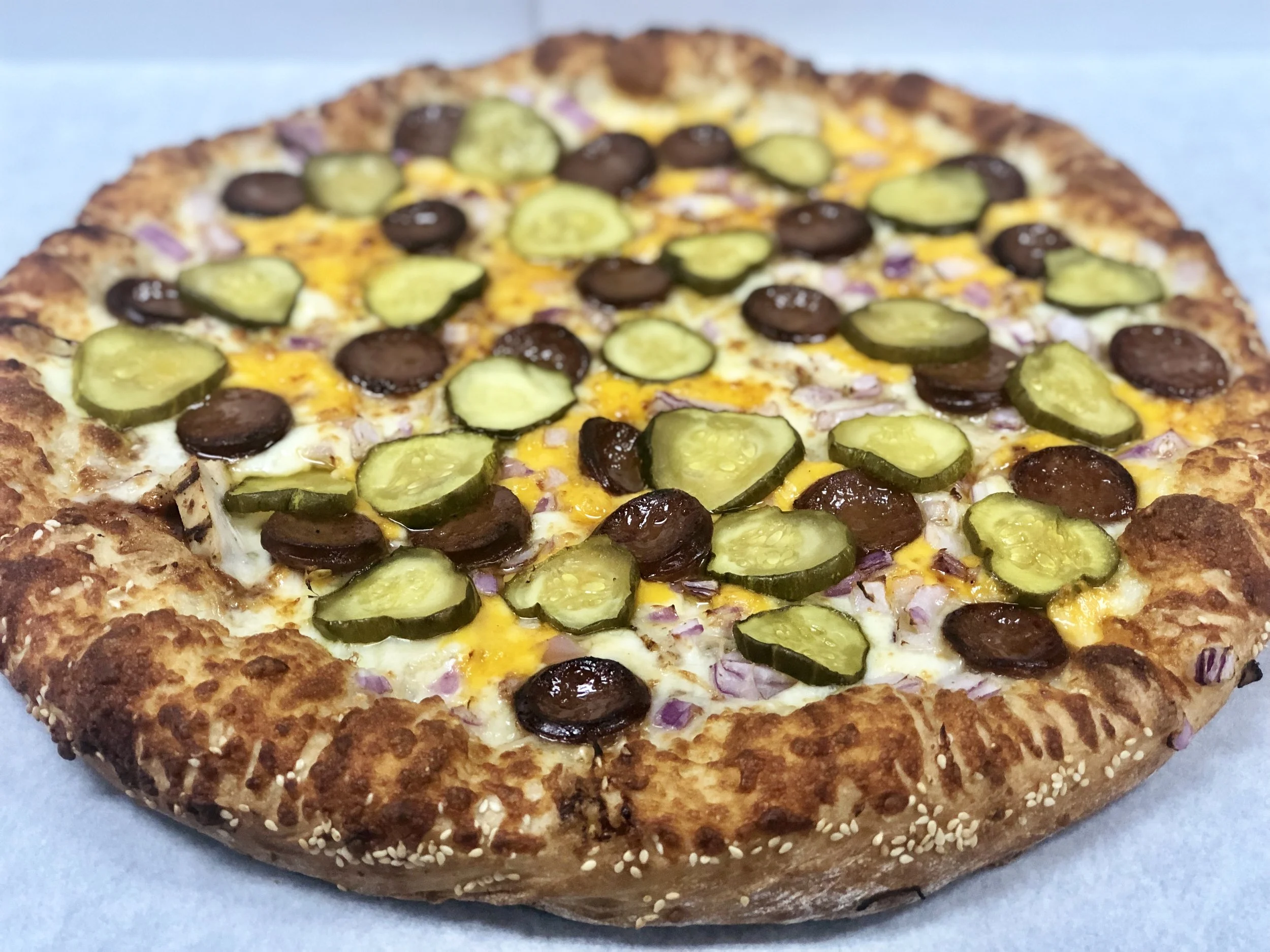 BBQ Picnic Pizza BBQ sauce, BBQ sausage, chicken, cheddar and mozzarella cheeses, onions, sweet-hotties pickles, and a sesame seed crust. Small Medium Large X-Large $15.93 $19.18 $22.13 $24.44 For more information on our BBQ Sausage from Little town Jerky, click HERE.