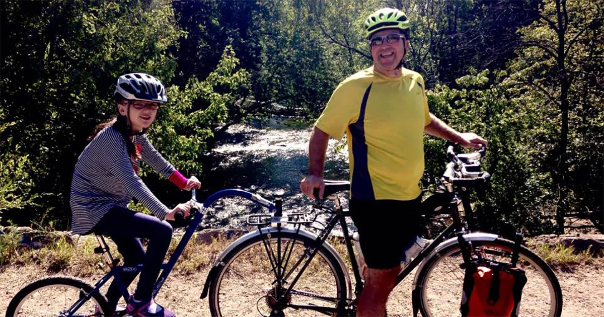 Lilia and her Dad with their sweet cycling set-up