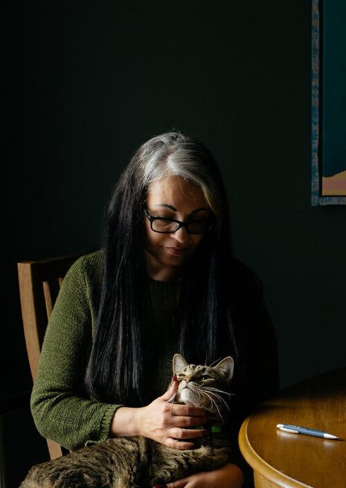 Ana Helfer, at home with one of her cats, Marley, survived years of emotional and physical abuse from her husband Credit Alex Flynn for The New York Times