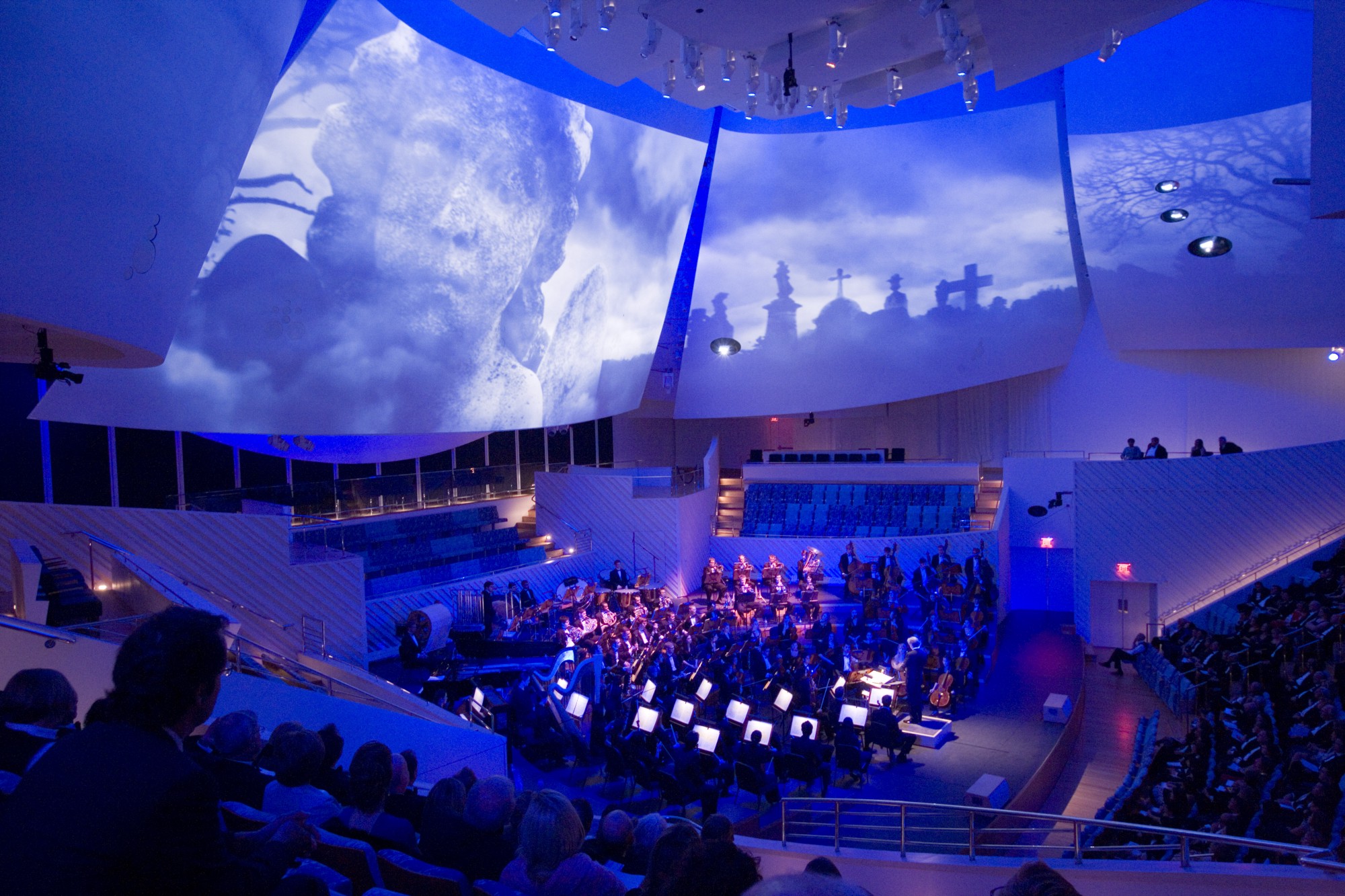 New World Symphony Hall with the giant curved sails above the stage in Frank Gehry’s signature twisting and organic style, on which the video is projected. (photo: New World Center)
