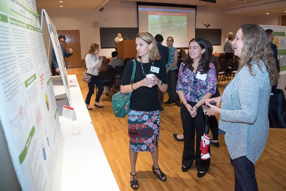 Rachel Dunifon, Sharon Glick, and Laura Tach viewing Sharon's CCE Internship poster. Sharon is a 2Gen Scholar