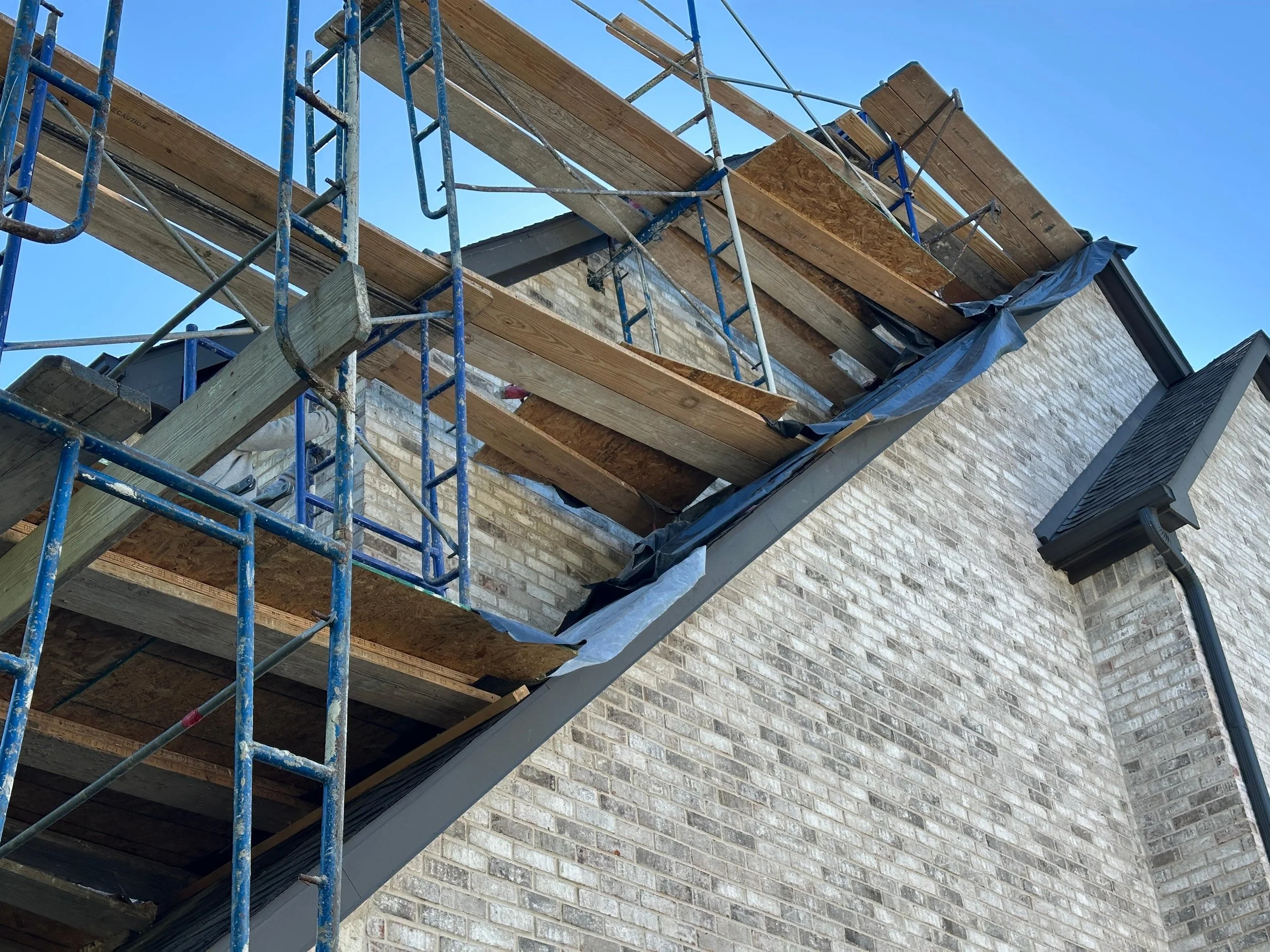 We removed the brick, installed steel lintel and added new water resistive barriers before replacing the brick