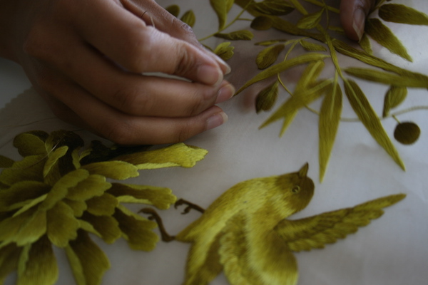 A Fromental wallcovering being hand-embroidered with incredible skill