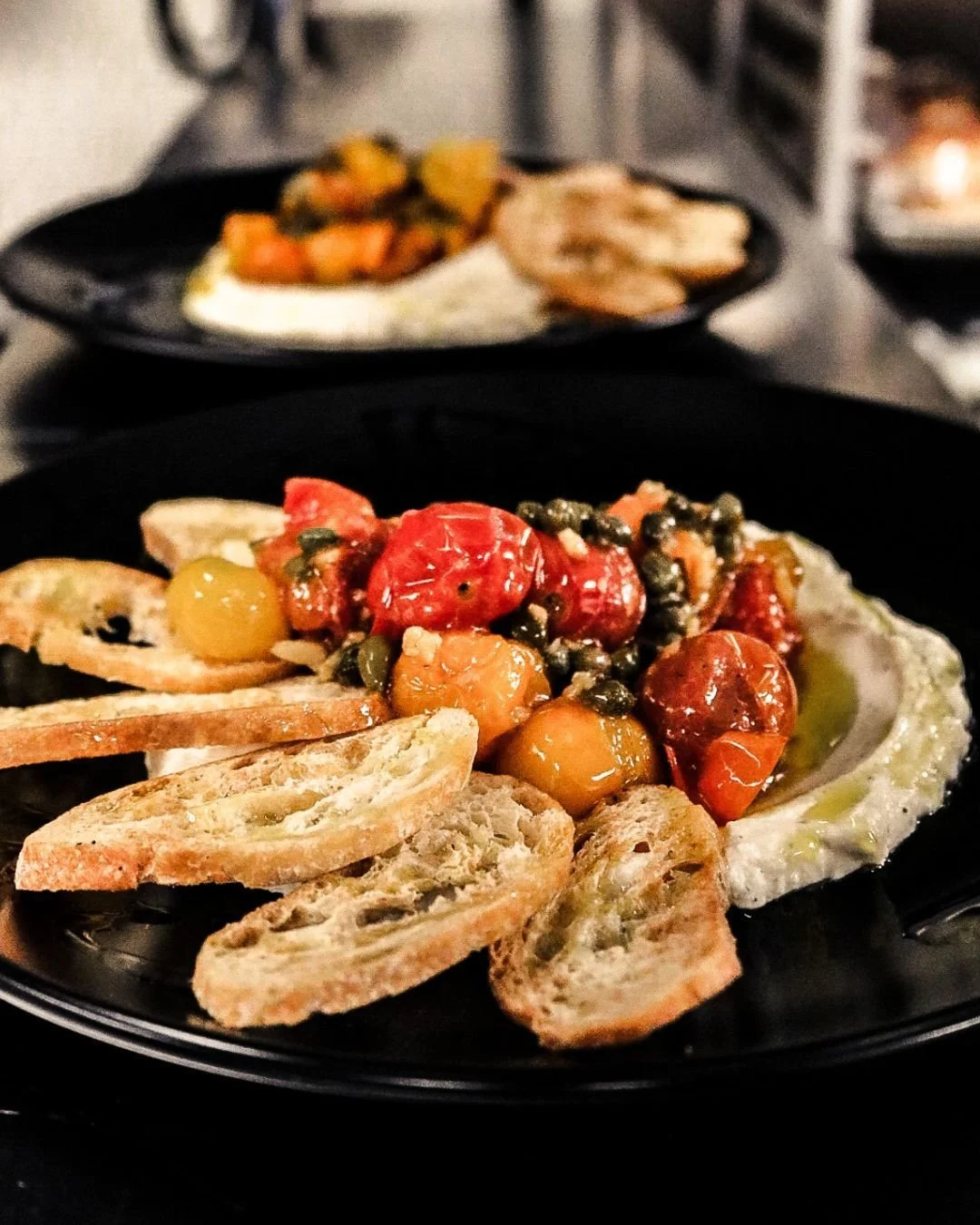 Creamy whipped ricotta, roasted cherry tomatoes, briny capers, fresh basil, and a drizzle of EVOO served with crisp toast points. Simple ingredients, big flavor. ✨

#CLEEats #WhippedRicotta #AppetizerGoals #PatioSeason