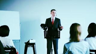 adult-businessman-standing-at-the-board-and-presenting-the-vr-headset-to-the-colleagues_hz4fcwa_e_thumbnail-small02.jpg
