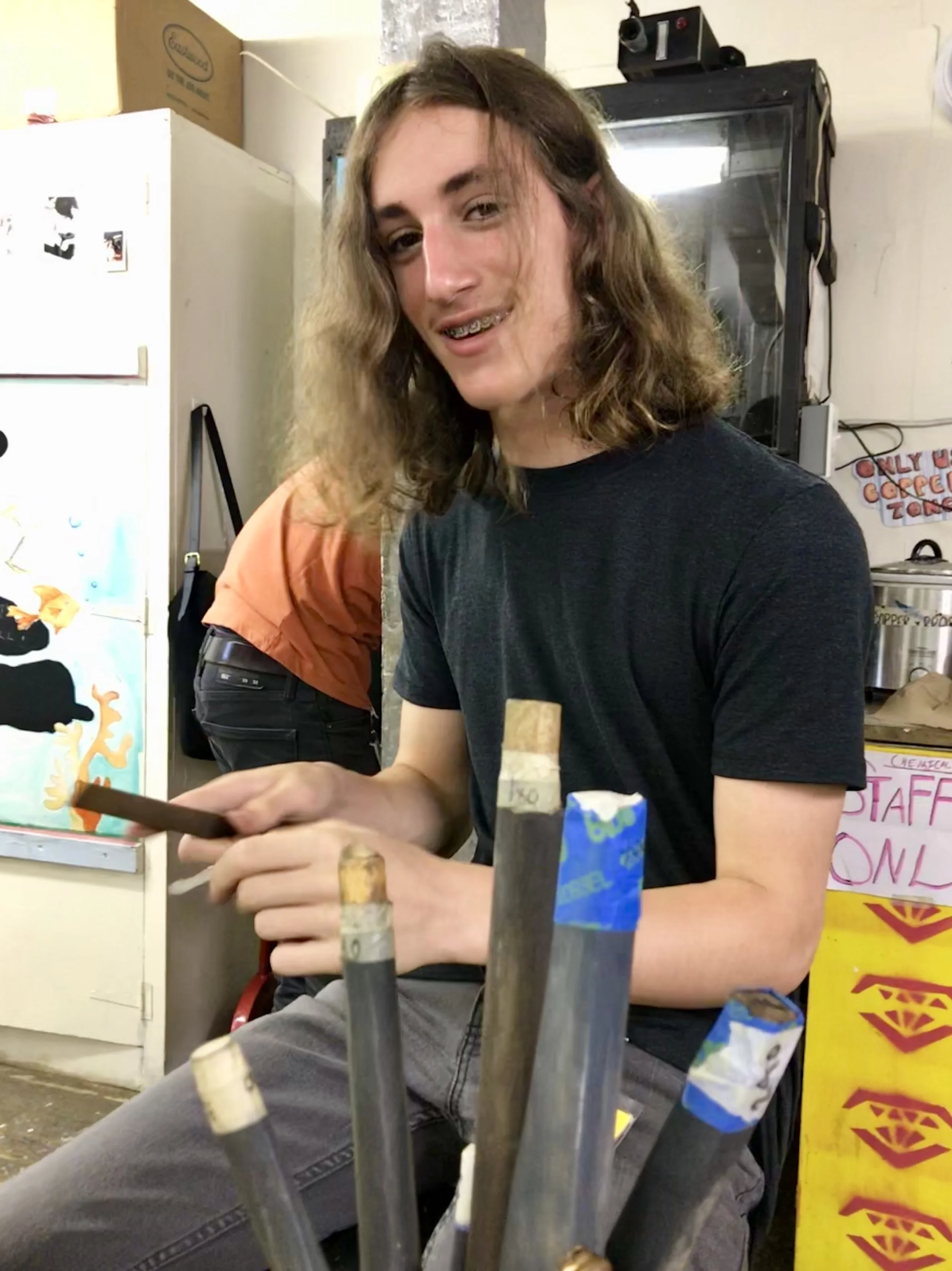 Filing handmade metal guitar picks.