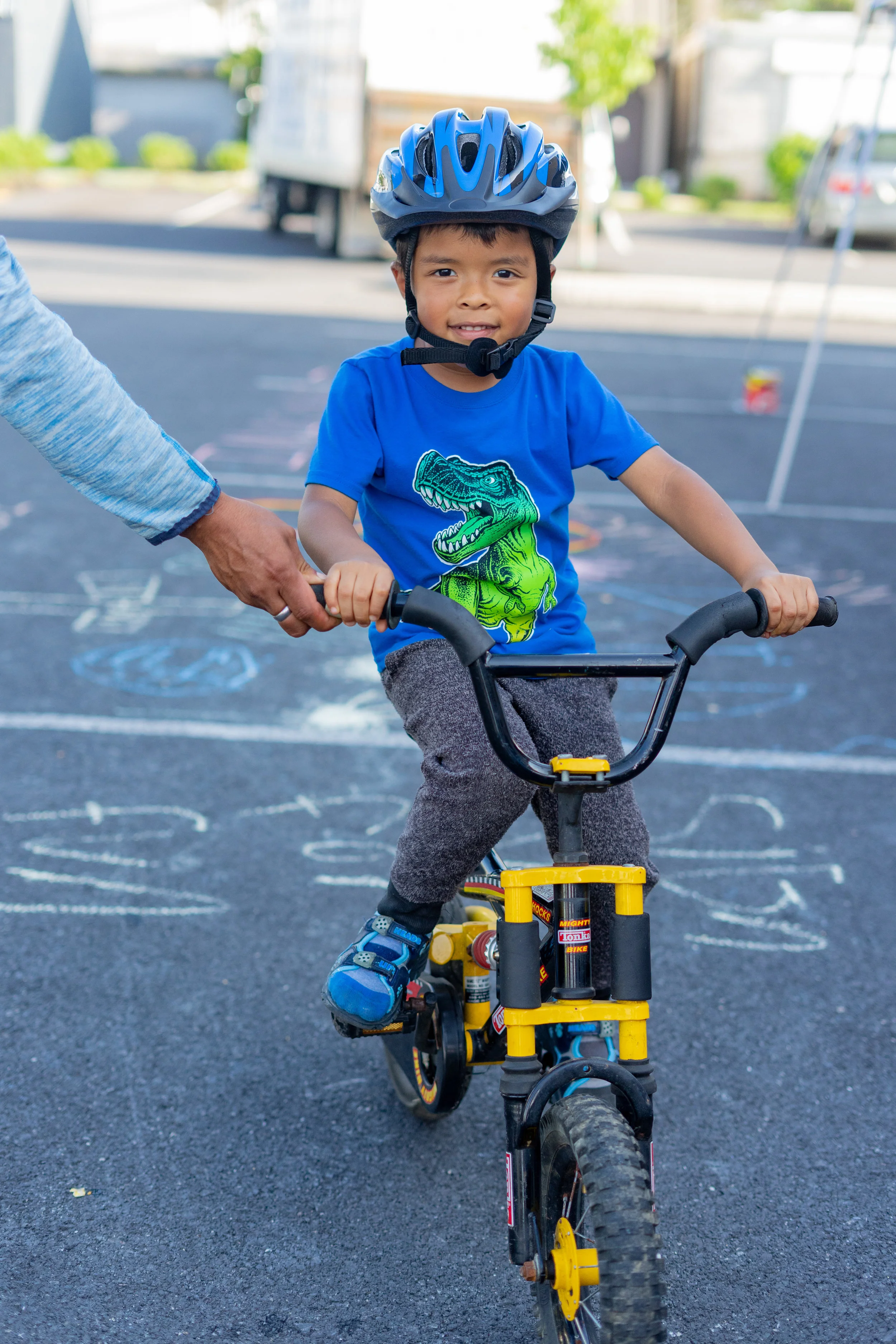 Noah G. poses with the bike he won in the Back-to-School fair raffle. Noah can't ride without training wheels yet, but is excited to learn.