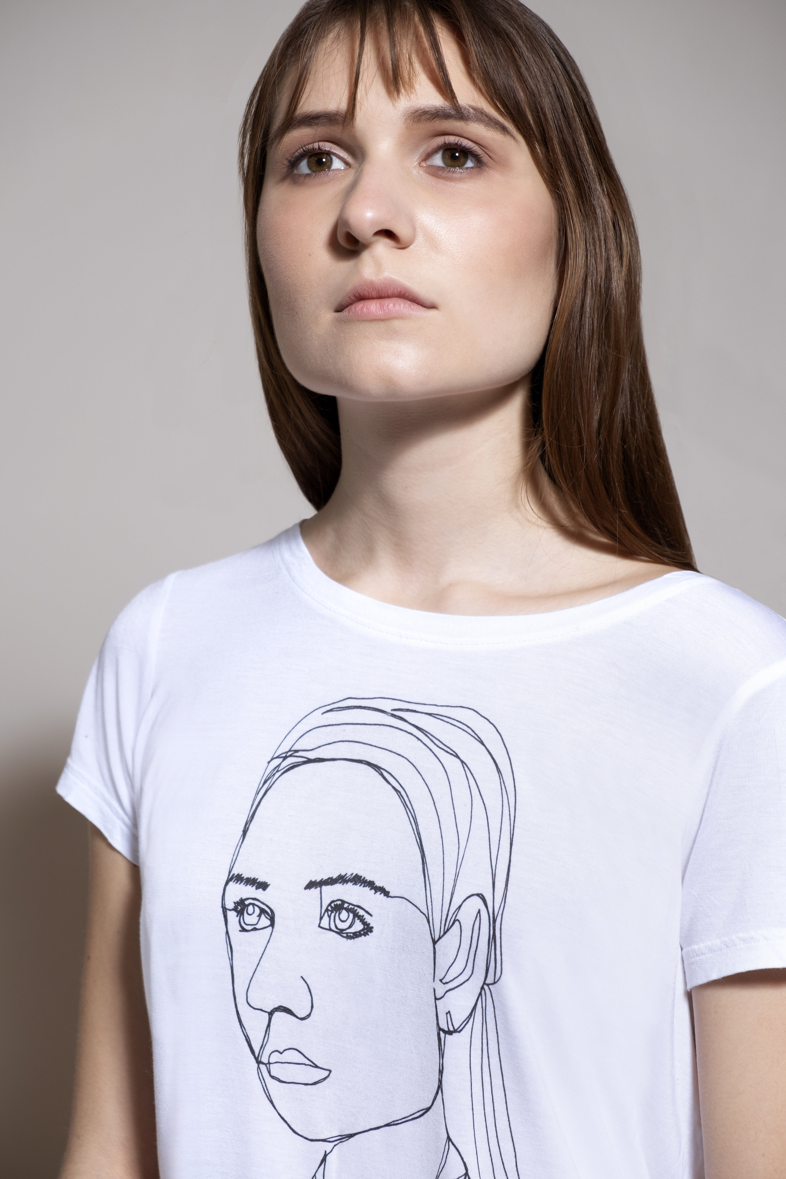 Agency model featuring her continuous line drawing likeness on a second hand 100% cotton tshirt.