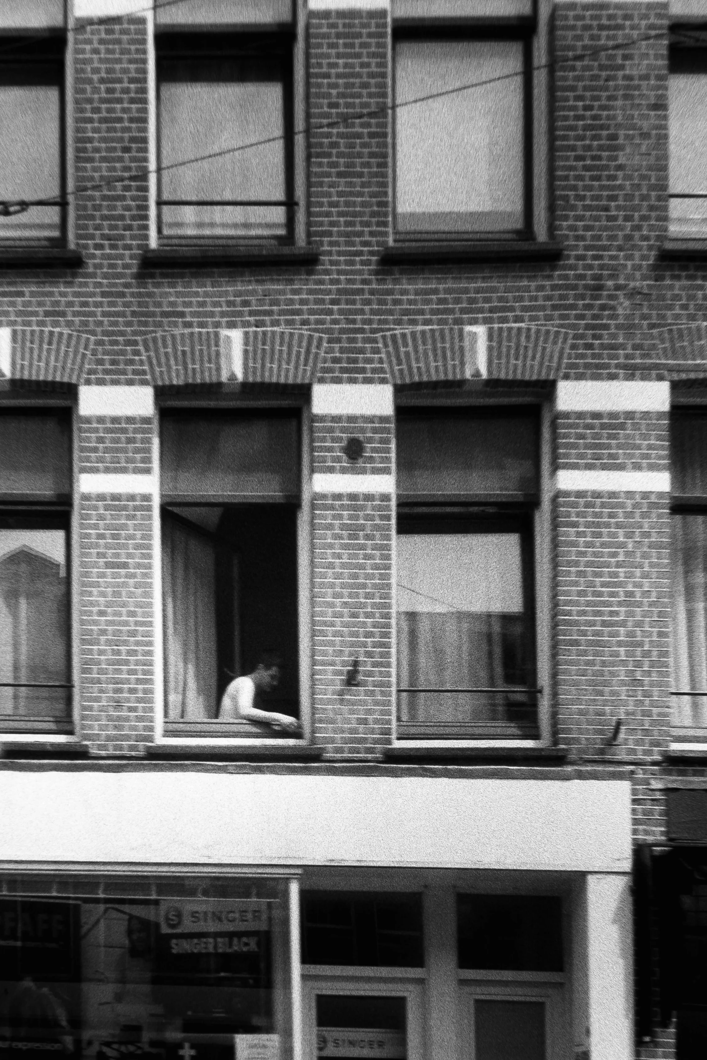 Man smoking by the window, May 29 2026 (Canon A35F, Kentmere 200)