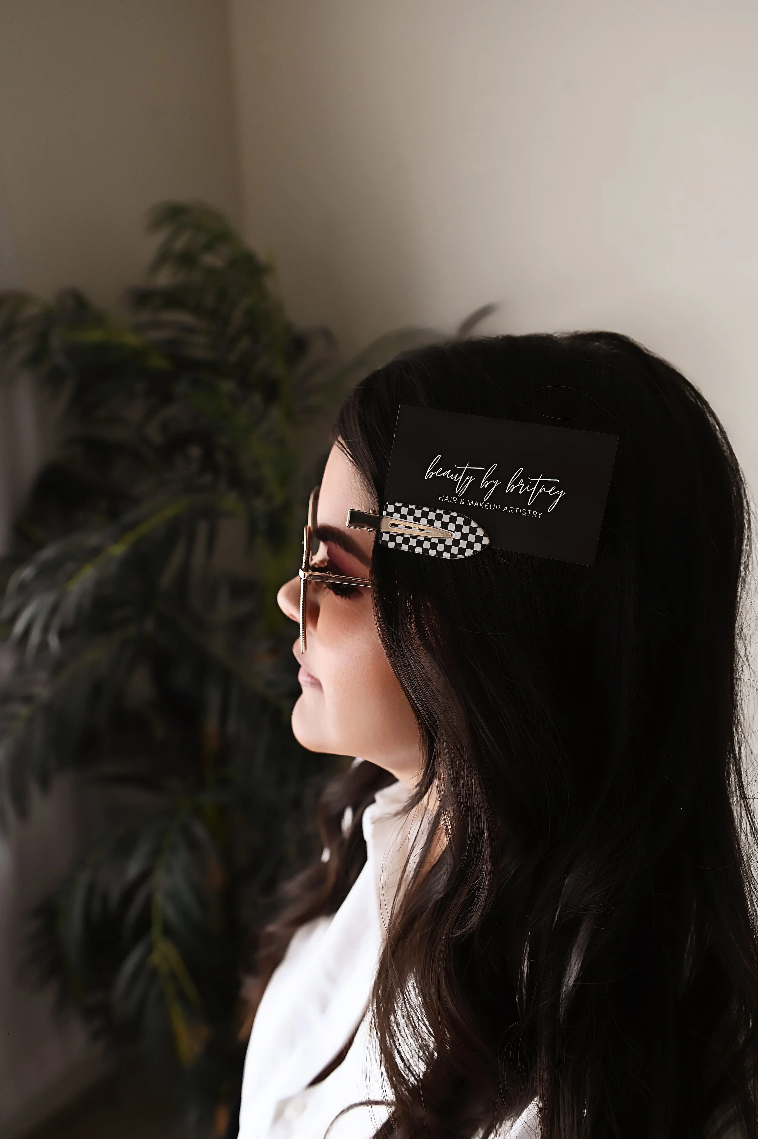 Side profile branding photo of Shreveport hair stylist Britney with soft studio light and minimal background