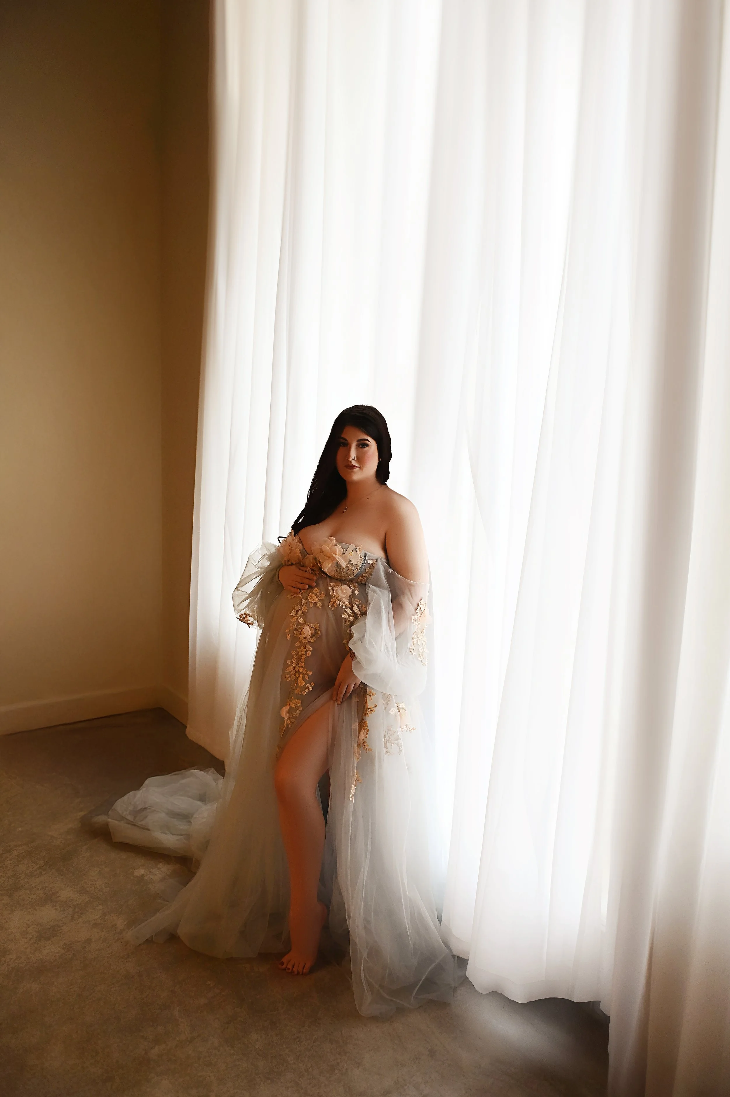 Studio maternity portrait of a pregnant woman in a sheer gown photographed in Shreveport Louisiana