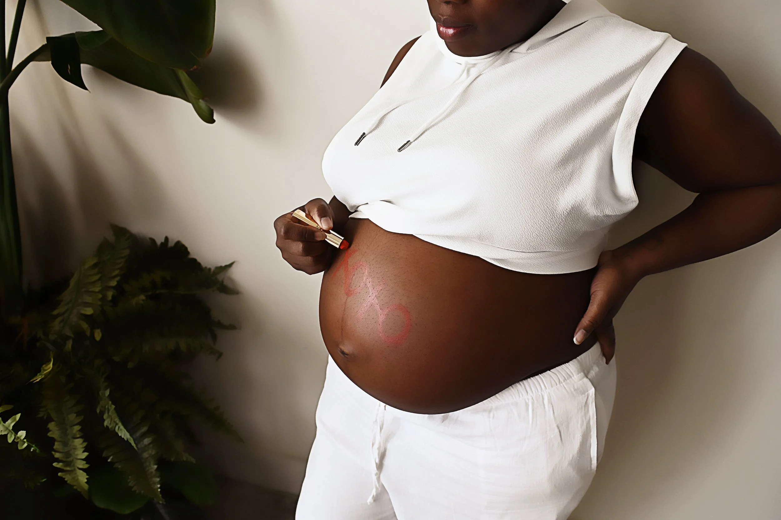close up maternity portrait with baby boy written on pregnant belly during maternity photography session