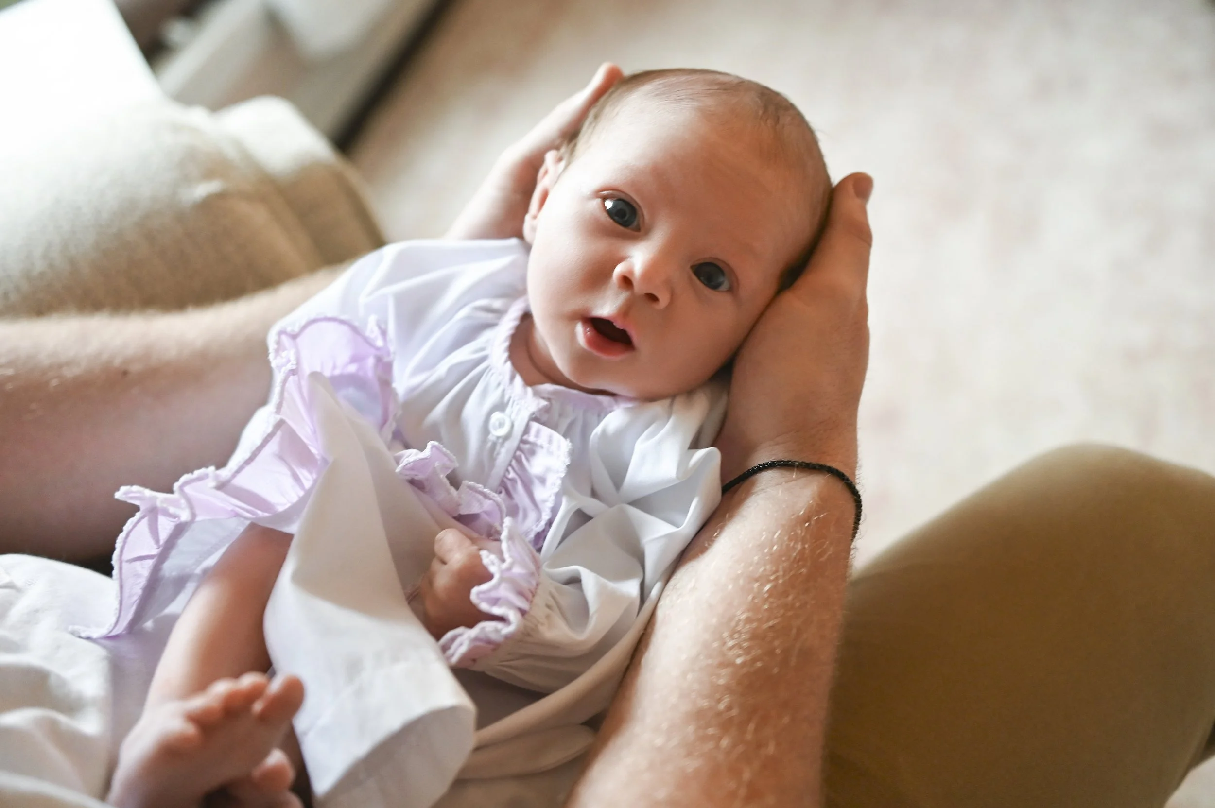 close up of newborn baby sleeping peacefully in parent hands