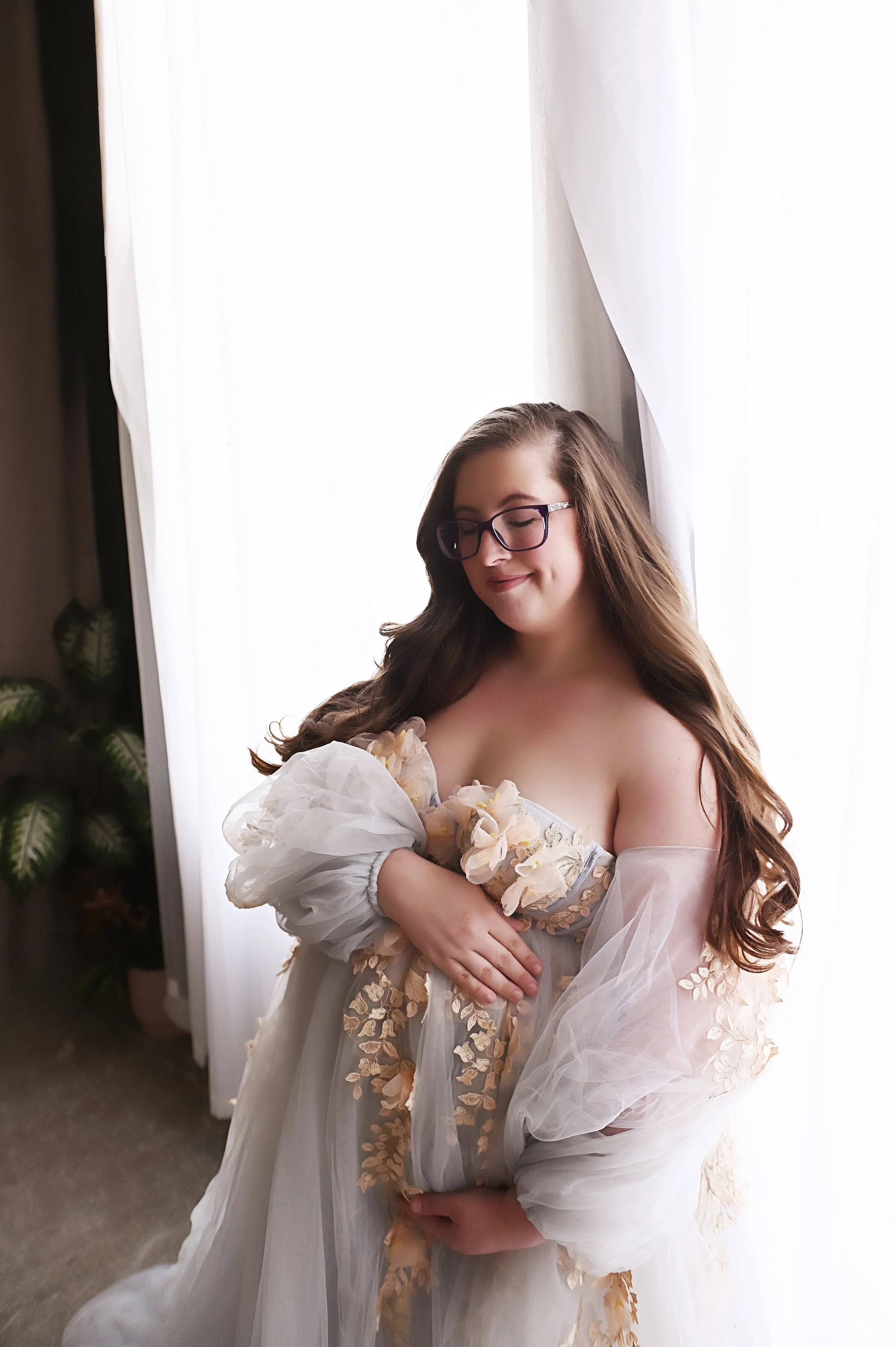 Pregnant woman in floral gown during studio maternity photography session in Shreveport Louisiana