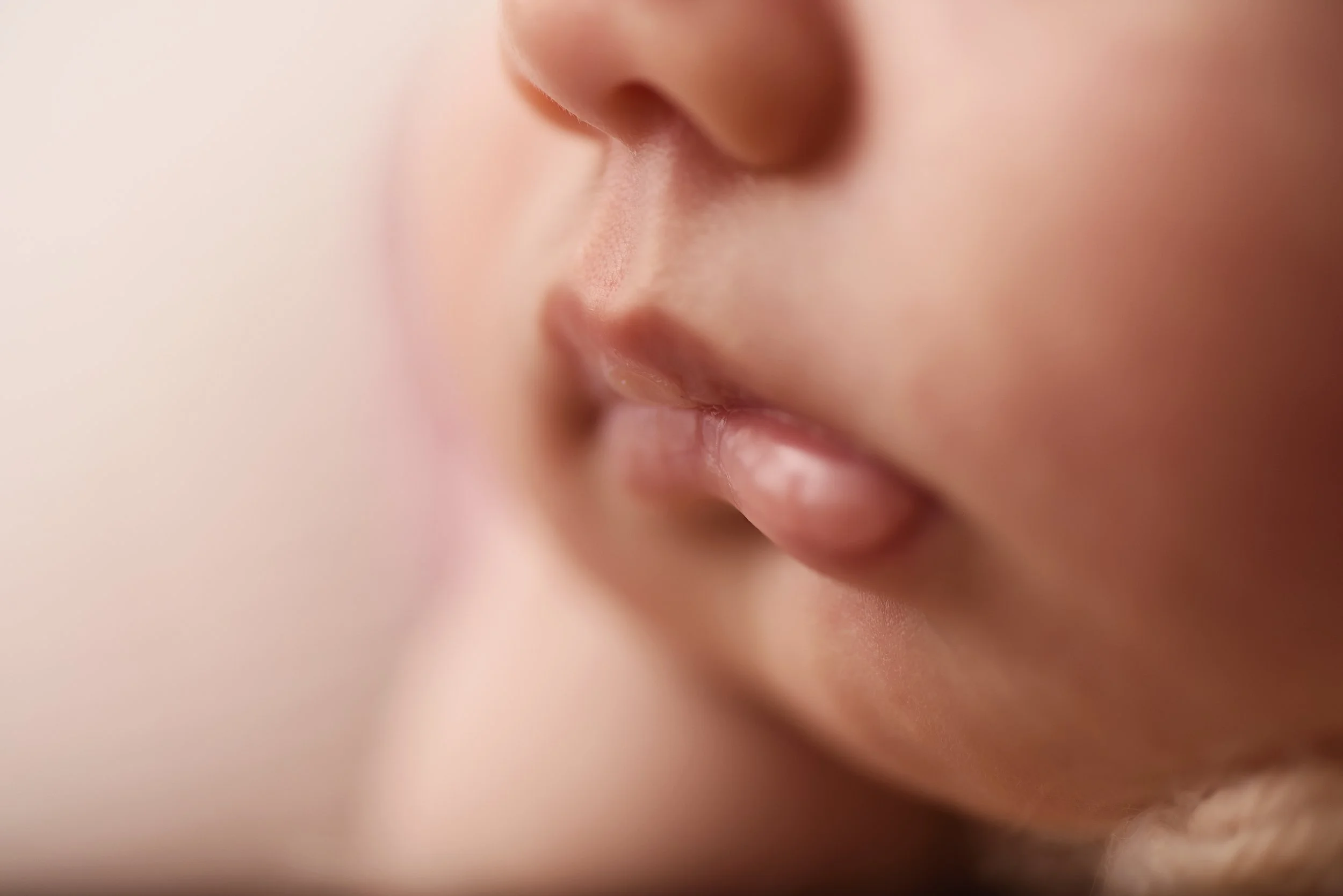Macro photo of newborn baby girl lips and chin