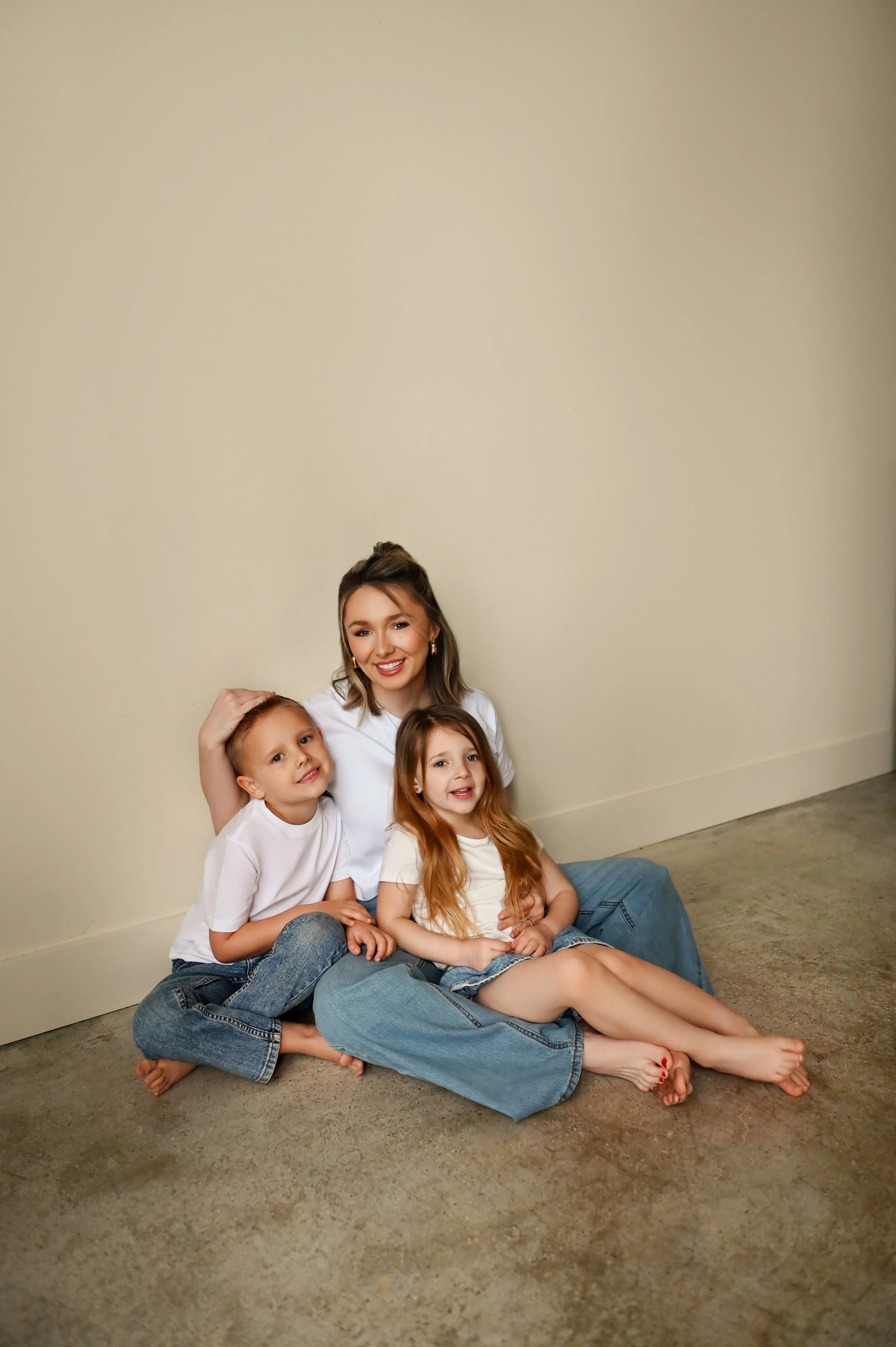 mother sitting on floor with son and daughter during motherhood mini session