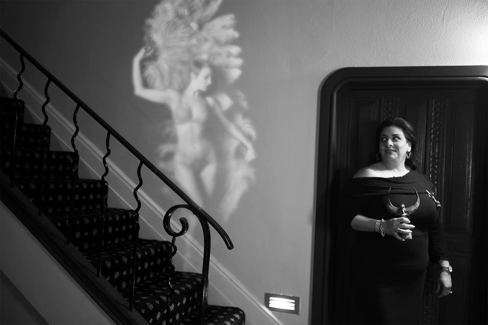 THE FEATHERED LADY Cynthia fanned flames that left hearts in ashes. Theater lamps set her ablaze with fiery, feathered flashes.