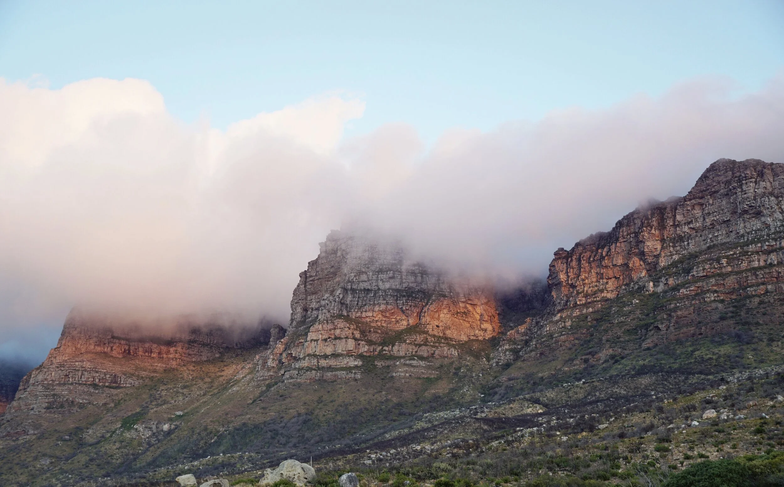 Table Mountain at sunset, with the clouds pouring through